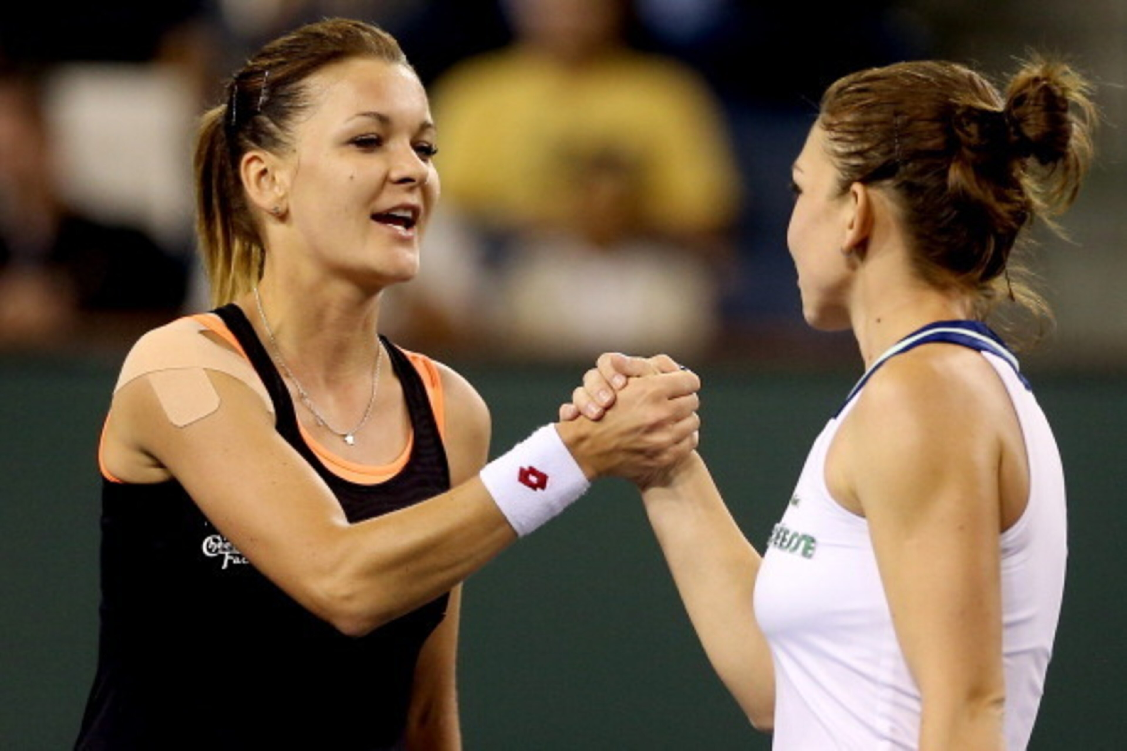 INDIAN WELLS, CA - MARCH 14:  Agnieszka Radwanska of Poland is congratulated by Simona Halep of Romania after their match during the semifinals of the BNP Parabas Open at the Indian Wells Tennis Garden on March 14, 2014 in Indian Wells, California.  (Phot