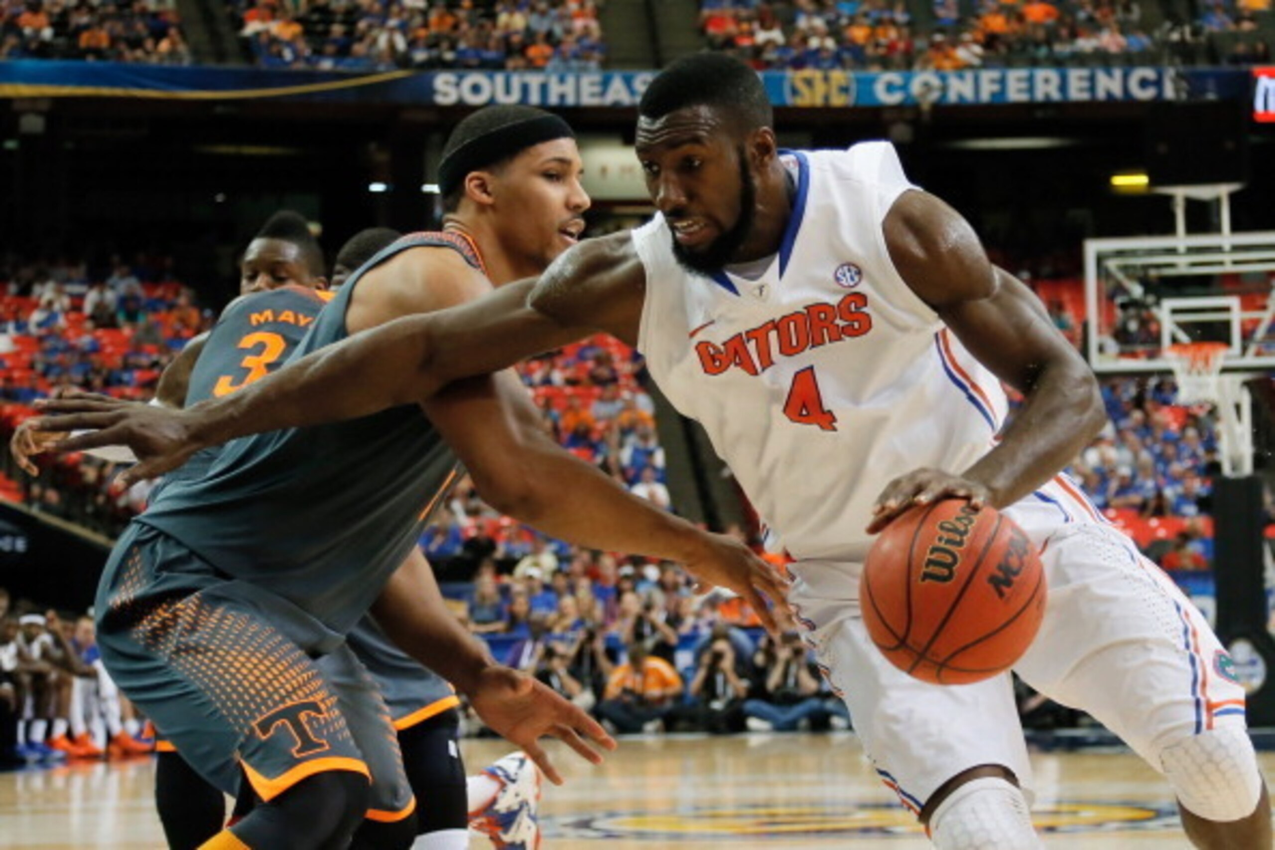 ATLANTA, GA - MARCH 15:  Patric Young #4 of the Florida Gators drives with the ball against Jarnell Stokes #5 of the Tennessee Volunteers during the semifinals of the SEC Men's Basketball Tournament at Georgia Dome on March 15, 2014 in Atlanta, Georgia.  