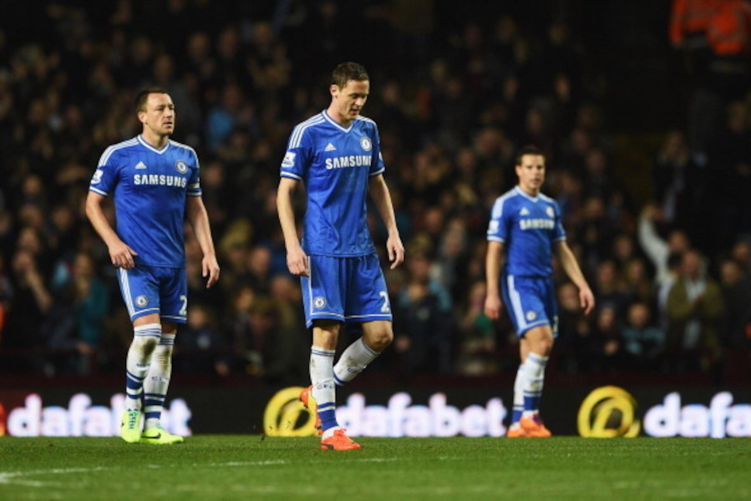 BIRMINGHAM, ENGLAND - MARCH 15:  (L-R) John Terry, Nemanja Matic and Cesar Azpilicueta of Chelsea look dejected as Fabian Delph of Aston Villa (not pictured) scores the first goal during the Barclays Premier League match between Aston Villa and Chelsea at