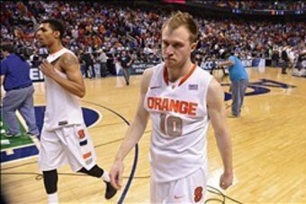 Mar 14, 2014; Greensboro, NC, USA;  Syracuse Orange guard Michael Gbinije (0) and guard Trevor Cooney (10) walk off the court. The Wolfpack defeated the Orange 66-63 in the quarterfinals of the ACC college basketball tournament at Greensboro Coliseum. Man