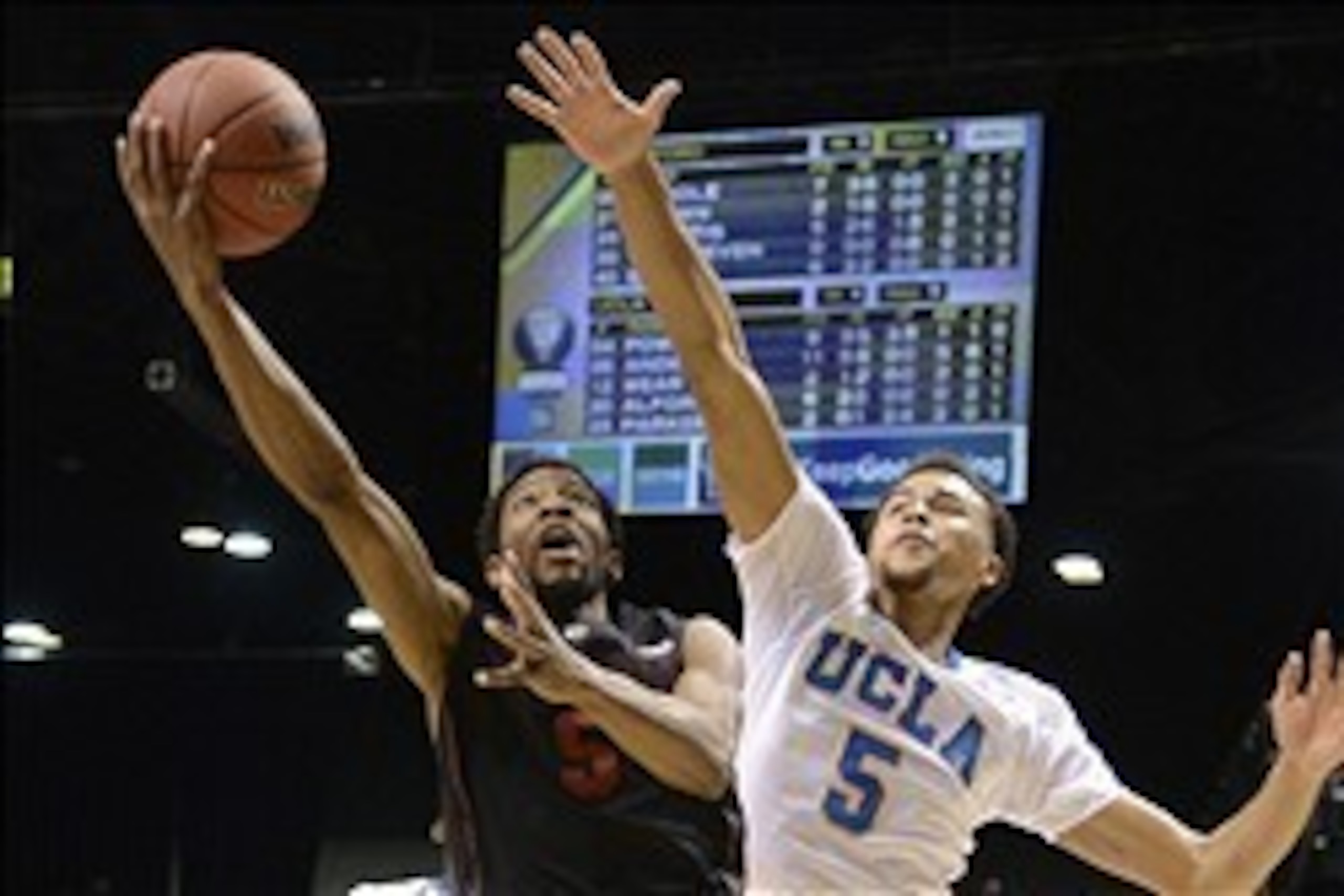 Mar 14, 2014; Las Vegas, NV, USA; Stanford Cardinal guard Chasson Randle (5, left) shoots against UCLA Bruins guard/forward Kyle Anderson (5, right) during the first half in the semifinals of the Pac-12 Conference college basketball tournament at MGM Gran