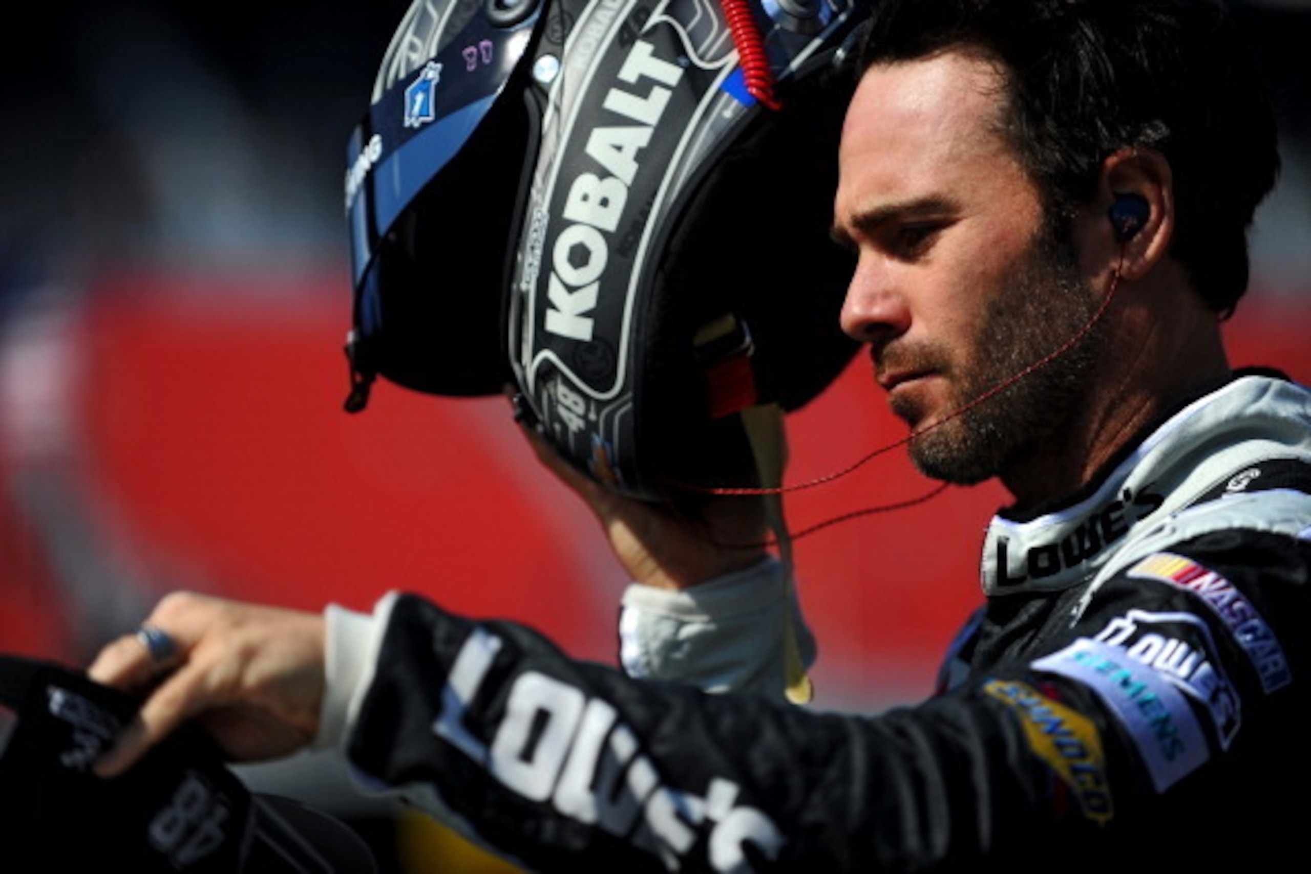 BRISTOL, TN - MARCH 15: Jimmie Johnson, driver of the #48 Kobalt Tools Chevrolet, takes off his helmet during practice for the NASCAR Sprint Cup Series Food City 500 at Bristol Motor Speedway on March 15, 2014 in Bristol, Tennessee.  (Photo by Will Schnee