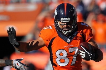 DENVER, CO - JANUARY 19:  Eric Decker #87 of the Denver Broncos tries to avod the tackle of  Logan Ryan #26 of the New England Patriots in the third quarter during the AFC Championship game at Sports Authority Field at Mile High on January 19, 2014 in Den