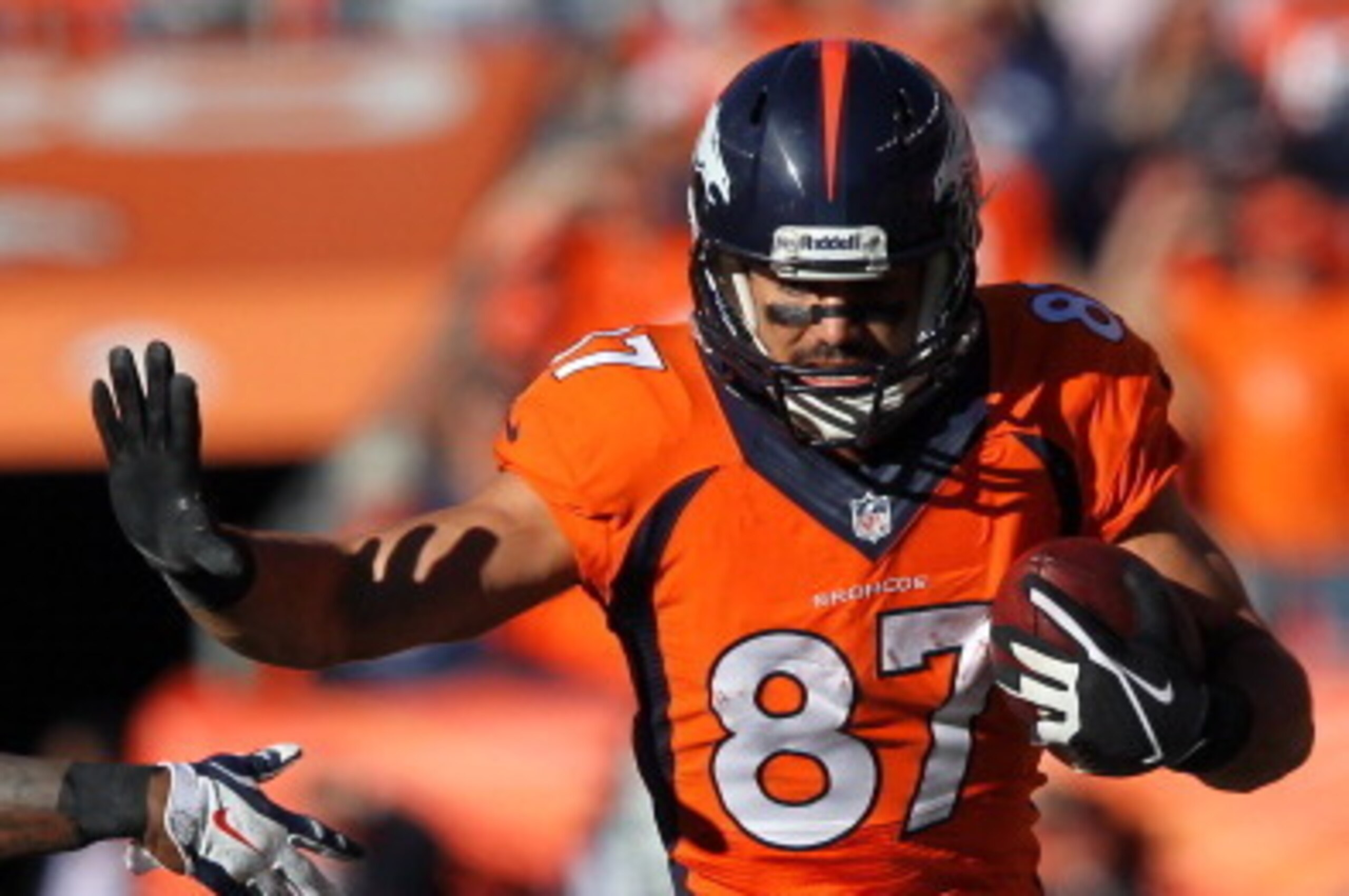 DENVER, CO - JANUARY 19:  Eric Decker #87 of the Denver Broncos tries to avod the tackle of  Logan Ryan #26 of the New England Patriots in the third quarter during the AFC Championship game at Sports Authority Field at Mile High on January 19, 2014 in Den