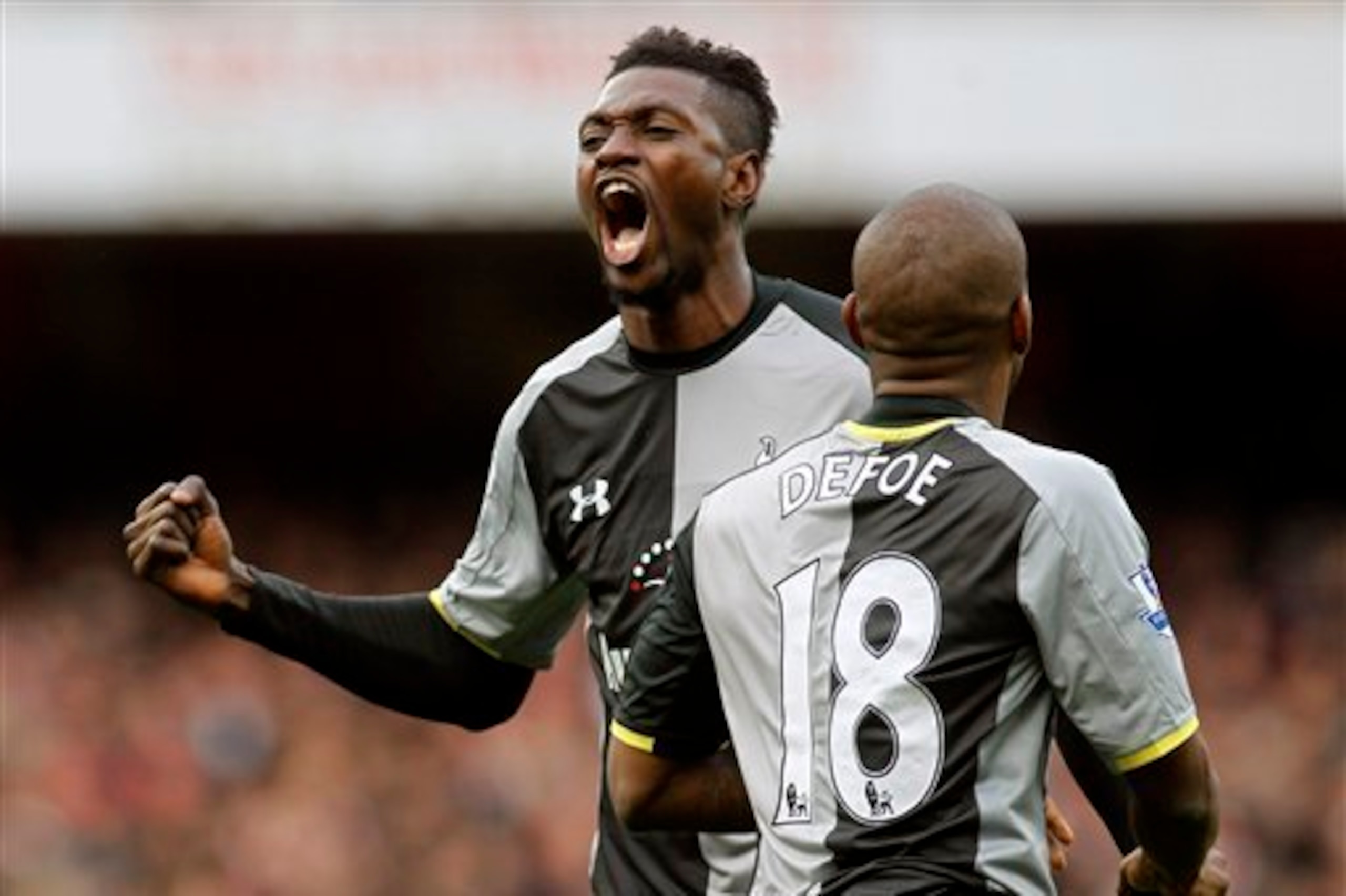 Adebayor celebrates a goal against Arsenal last season.