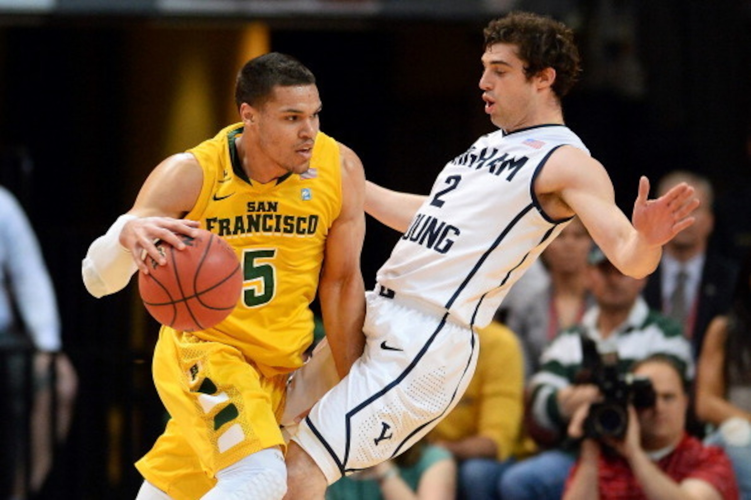 LAS VEGAS, NV - MARCH 10:  Matt Glover #5 of the San Francisco Dons drives against Matt Carlino #2 of the Brigham Young Cougars during a semifinal game of the West Coast Conference Basketball tournament at the Orleans Arena on March 10, 2014 in Las Vegas,