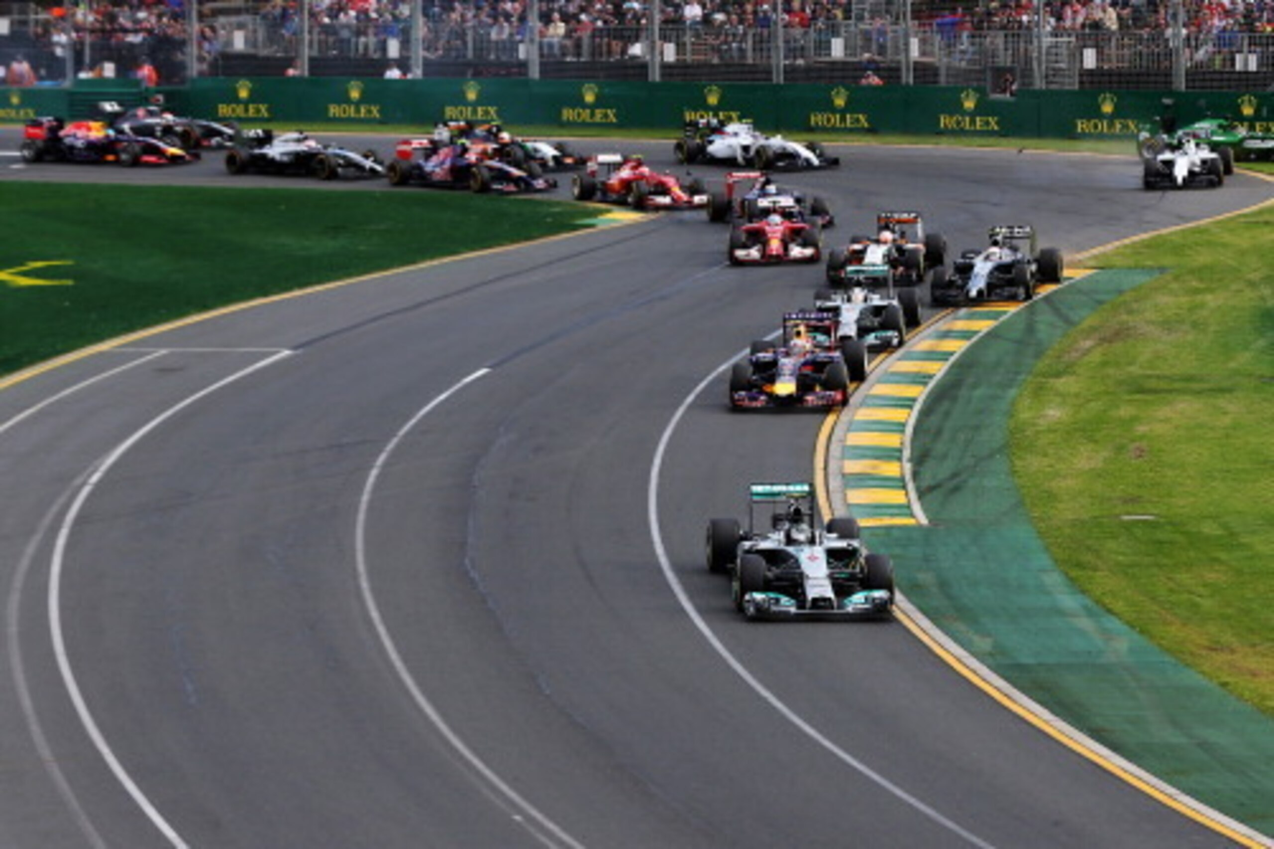 MELBOURNE, AUSTRALIA - MARCH 16:  Nico Rosberg of Germany and Mercedes GP leads the field into the first corner as in the background Felipe Massa of Brazil and Williams and Kamui Kobayashi of Japan and Caterham come together and spin out at the start of t
