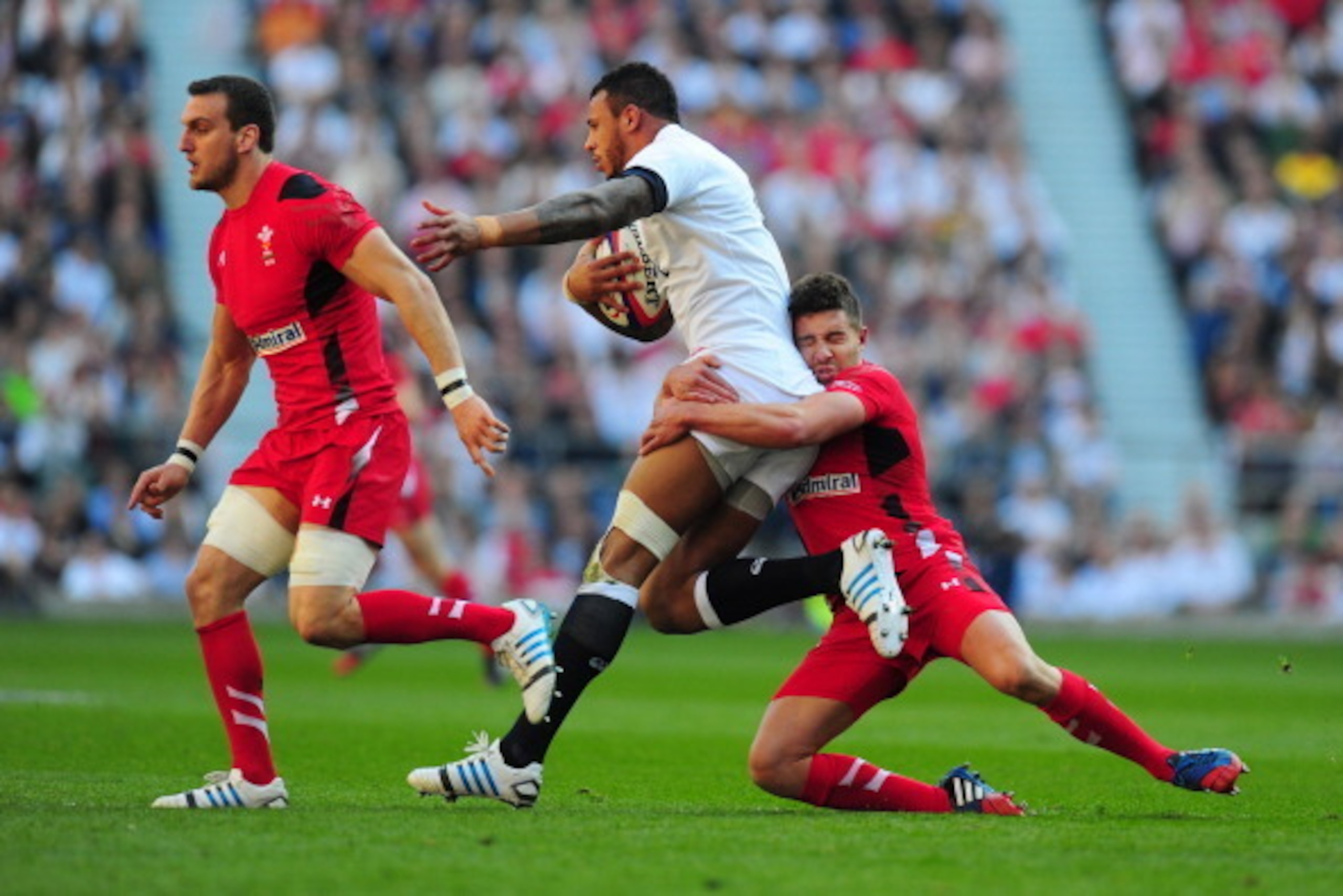 LONDON, ENGLAND - MARCH 09:  Courtney Lawes of England is tackled by Rhys Webb of Wales during the RBS Six Nations match between England and Wales at Twickenham Stadium on March 9, 2014 in London, England.  (Photo by Stu Forster/Getty Images)