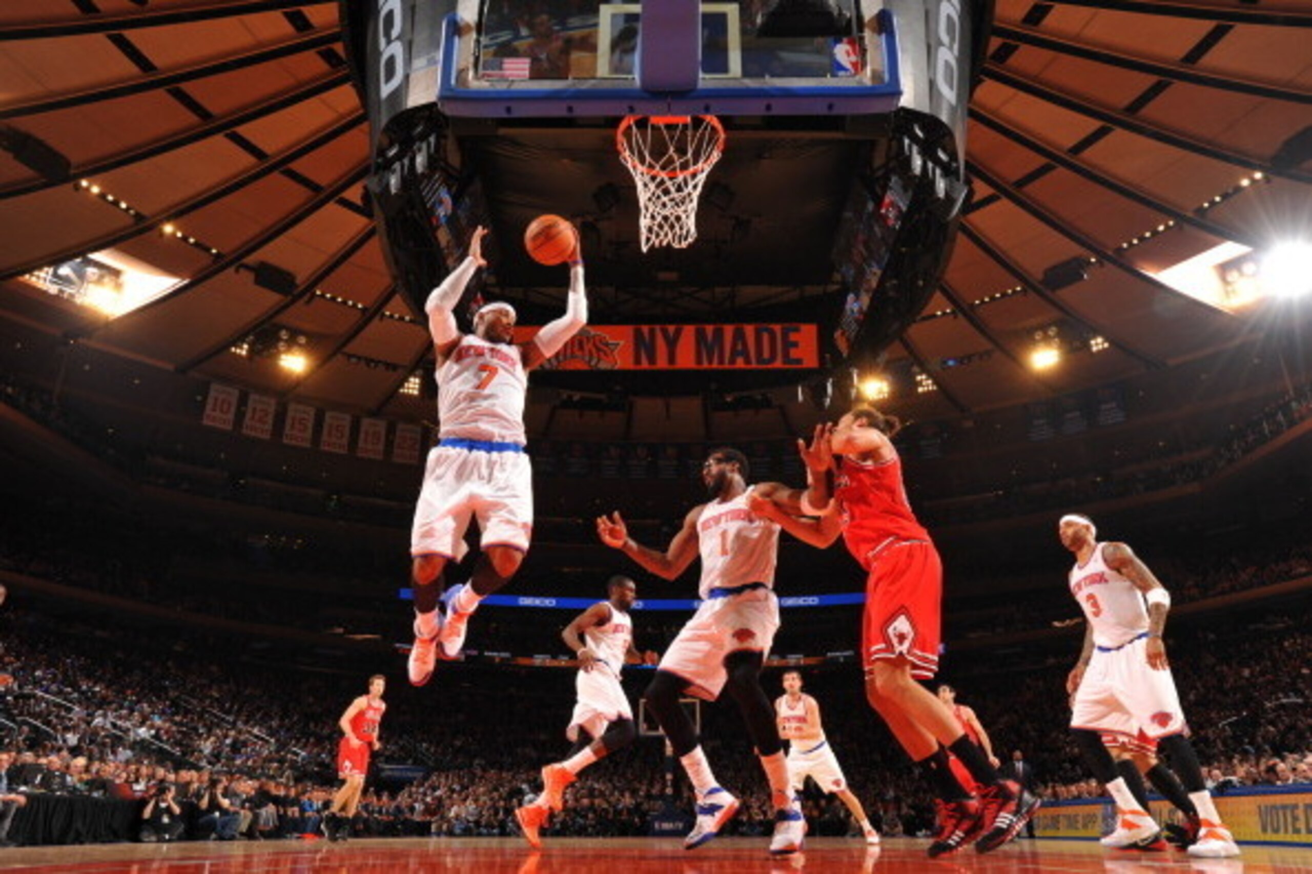 NEW YORK, NY - DECEMBER 11: Carmelo Anthony #7 of the New York Knicks rebounds against the Chicago Bulls during the game on December 11, 2013 at Madison Square Garden in New York City, New York. NOTE TO USER: User expressly acknowledges and agrees that, b