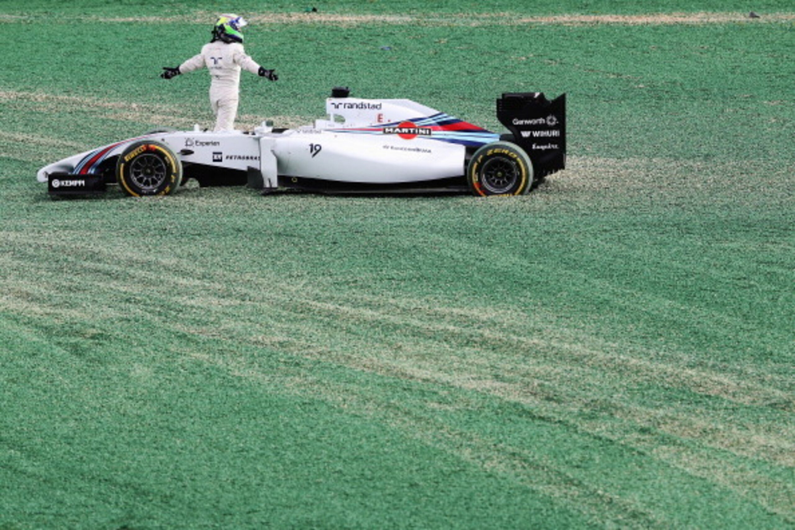MELBOURNE, AUSTRALIA - MARCH 16:  Felipe Massa (pictured) of Brazil and Williams and Kamui Kobayashi of Japan and Caterham come together and spin out into the gravel at turn one at the start of the Australian Formula One Grand Prix at Albert Park on March