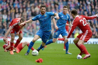 GLASGOW, SCOTLAND - MARCH 16:  Ryan Jack of Aberdeen tackles Ross Draper of Caledonian Thistle during the Scottish Communities League Cup Final at Celtic Park Stadium between Aberdeen and Caledonian Thistle on March 16, 2014 in Glasgow, Scotland.  (Photo