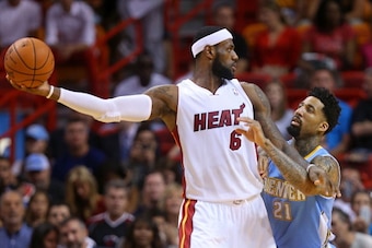 MIAMI, FL - MARCH 14: LeBron James #6 of the Miami Heat is defended by Wilson Chandler #21 of the Denver Nuggets during a game  at American Airlines Arena on March 14, 2014 in Miami, Florida. NOTE TO USER: User expressly acknowledges and agrees that, by d