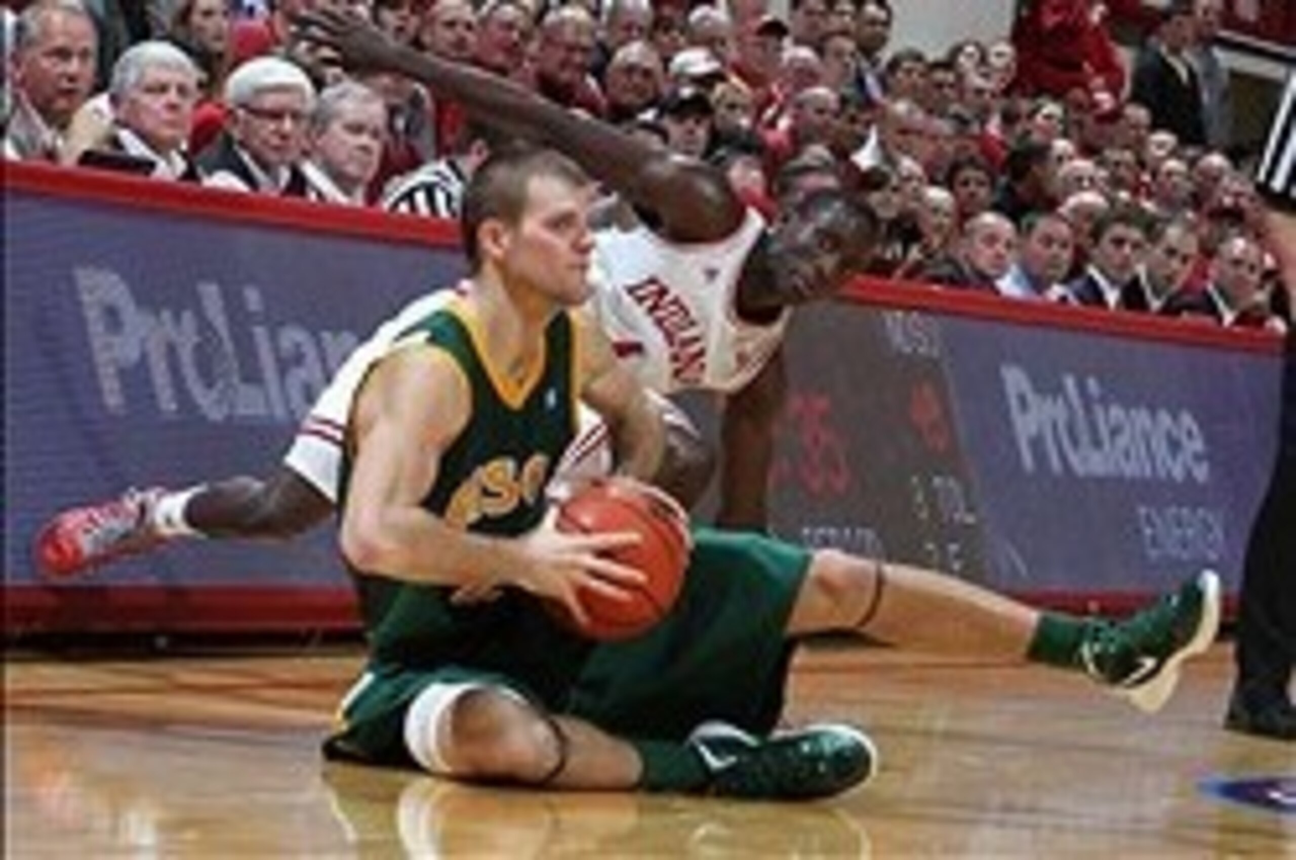 Nov 12, 2012; Bloomington, IN, USA; North Dakota State Bison guard Taylor Braun (24) makes a pass while on the ground against Indiana Hoosiers guard Victor Oladipo (4) at Assembly Hall. Indiana defeats North Dakota State 87-61. Mandatory Credit: Brian Spu