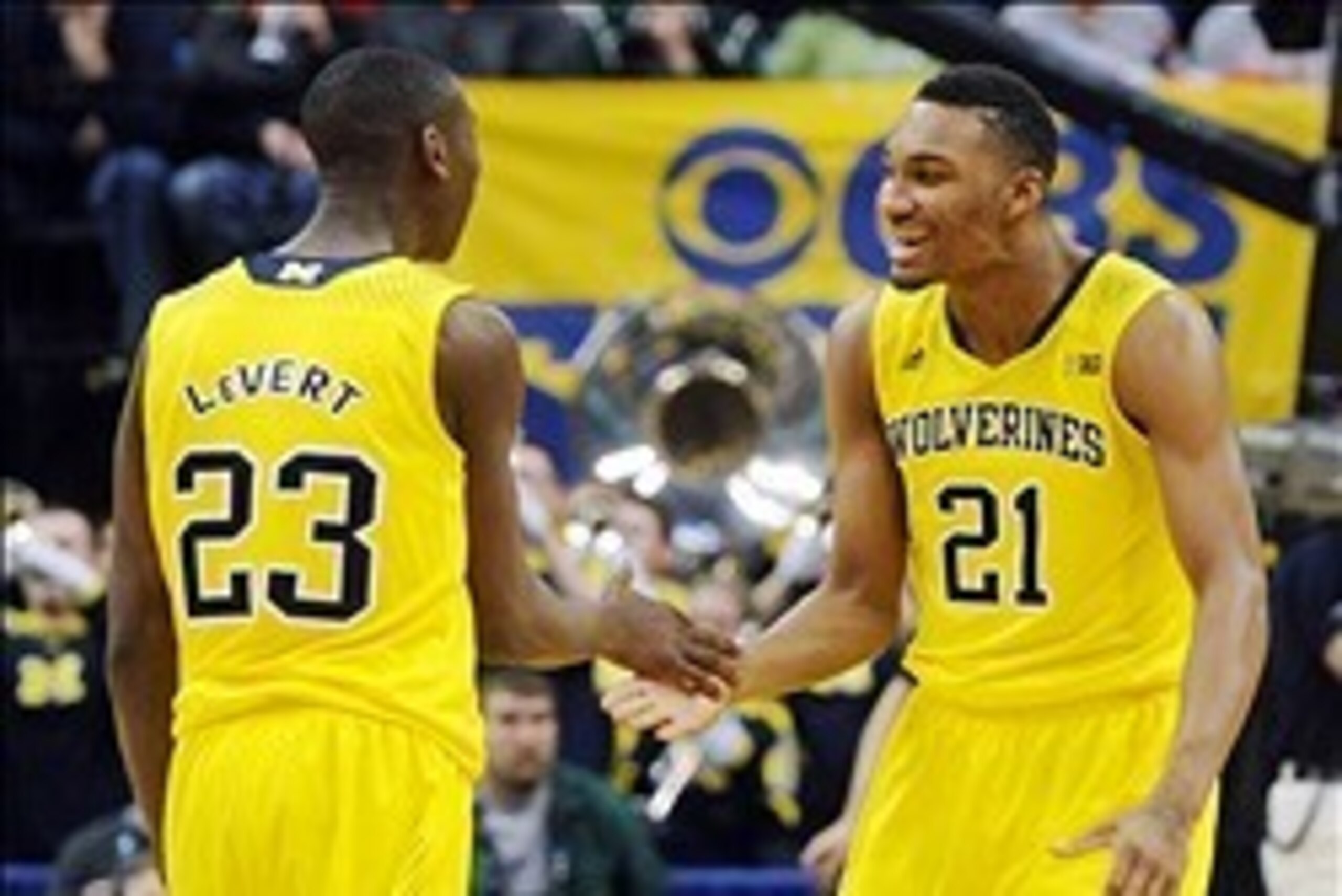 Mar 15, 2014; Indianapolis, IN, USA; Michigan Wolverines guard Caris LeVert (23) and guard Zak Irvin (21) celebrate during the semifinals of the Big Ten college basketball tournament against the Ohio State Buckeyes at Bankers Life Fieldhouse. Michigan won