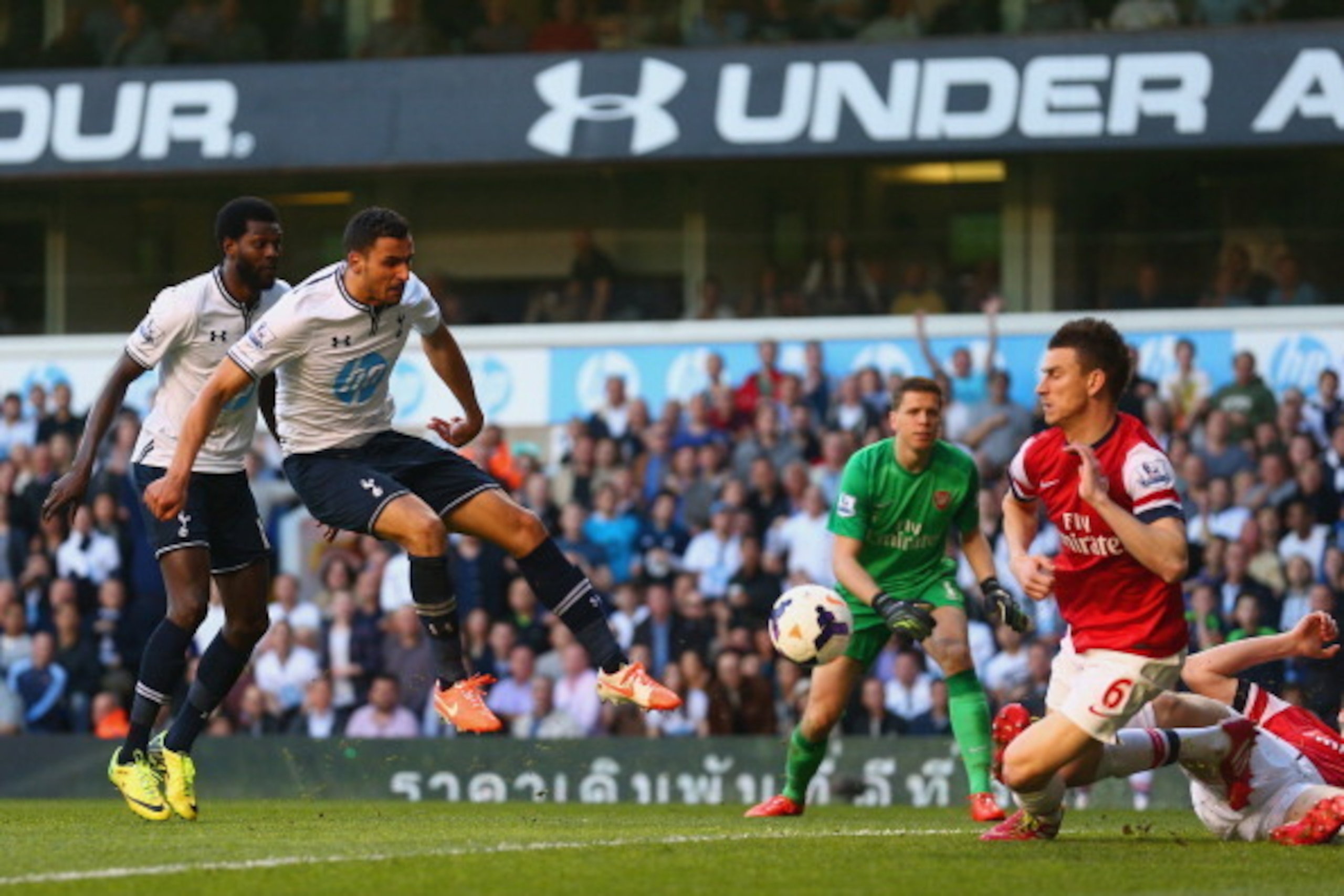 LONDON, ENGLAND - MARCH 16:  Laurent Koscielny of Arsenal blocks the effort from Nabil Bentaleb of Tottenham Hotspur during the Barclays Premier League match between Tottenham Hotspur and Arsenal at White Hart Lane on March 16, 2014 in London, England.  (