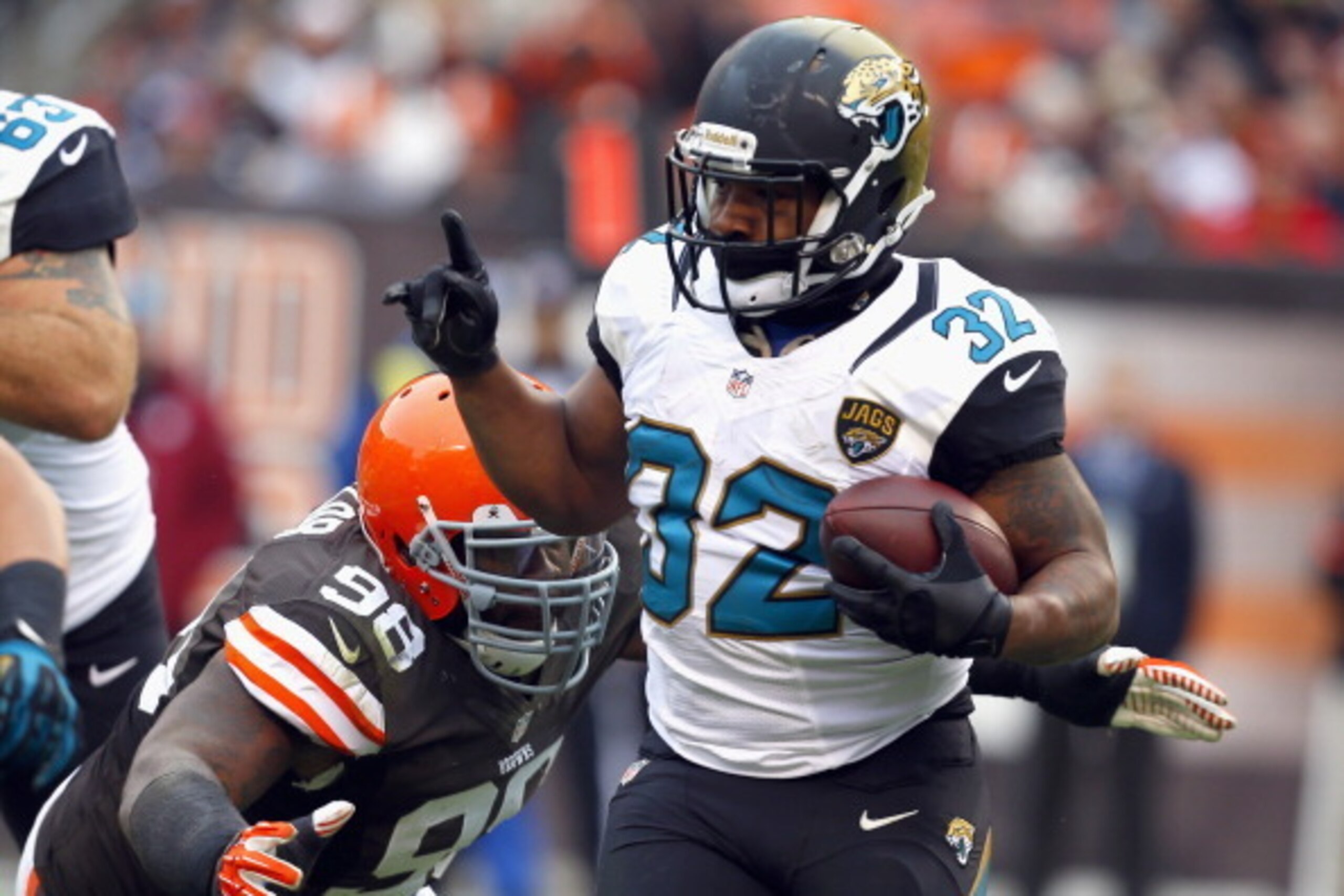 CLEVELAND, OH - DECEMBER 01:  Running back Maurice Jones-Drew #32 of the Jacksonville Jaguars runs the ball by defensive lineman Phil Taylor #98 of the Cleveland Browns at FirstEnergy Stadium on December 1, 2013 in Cleveland, Ohio.  (Photo by Matt Sulliva