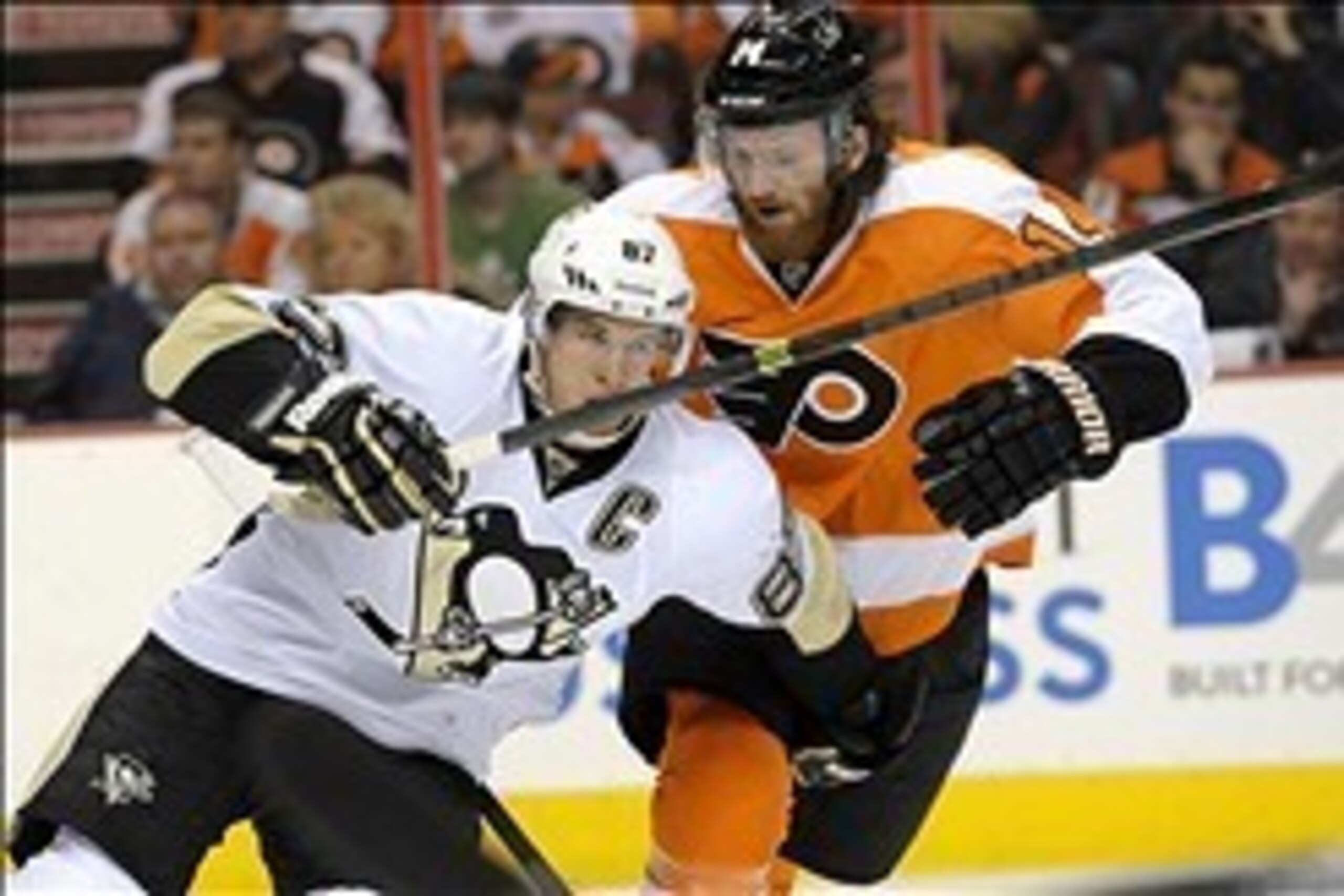 Mar 15, 2014; Philadelphia, PA, USA; Pittsburgh Penguins center Sidney Crosby (87) tries to skate around Philadelphia Flyers center Sean Couturier (14) during the first period at Wells Fargo Center. Mandatory Credit: Eric Hartline-USA TODAY Sports