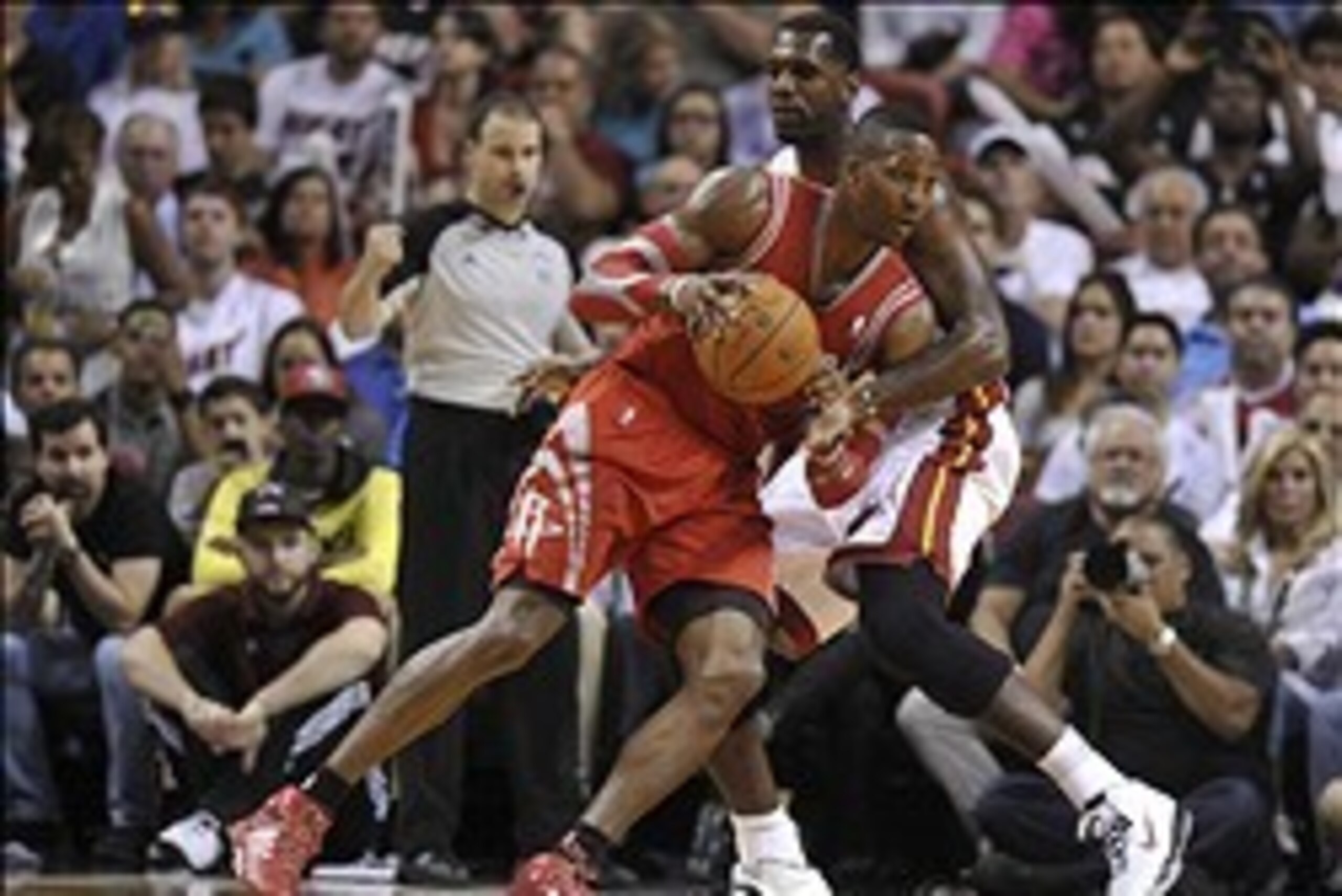Mar 16, 2014; Miami, FL, USA; Houston Rockets center Dwight Howard (12) drives to the basket as Miami Heat center Greg Oden (20) defends during the second half at American Airlines Arena. Mandatory Credit: Steve Mitchell-USA TODAY Sports