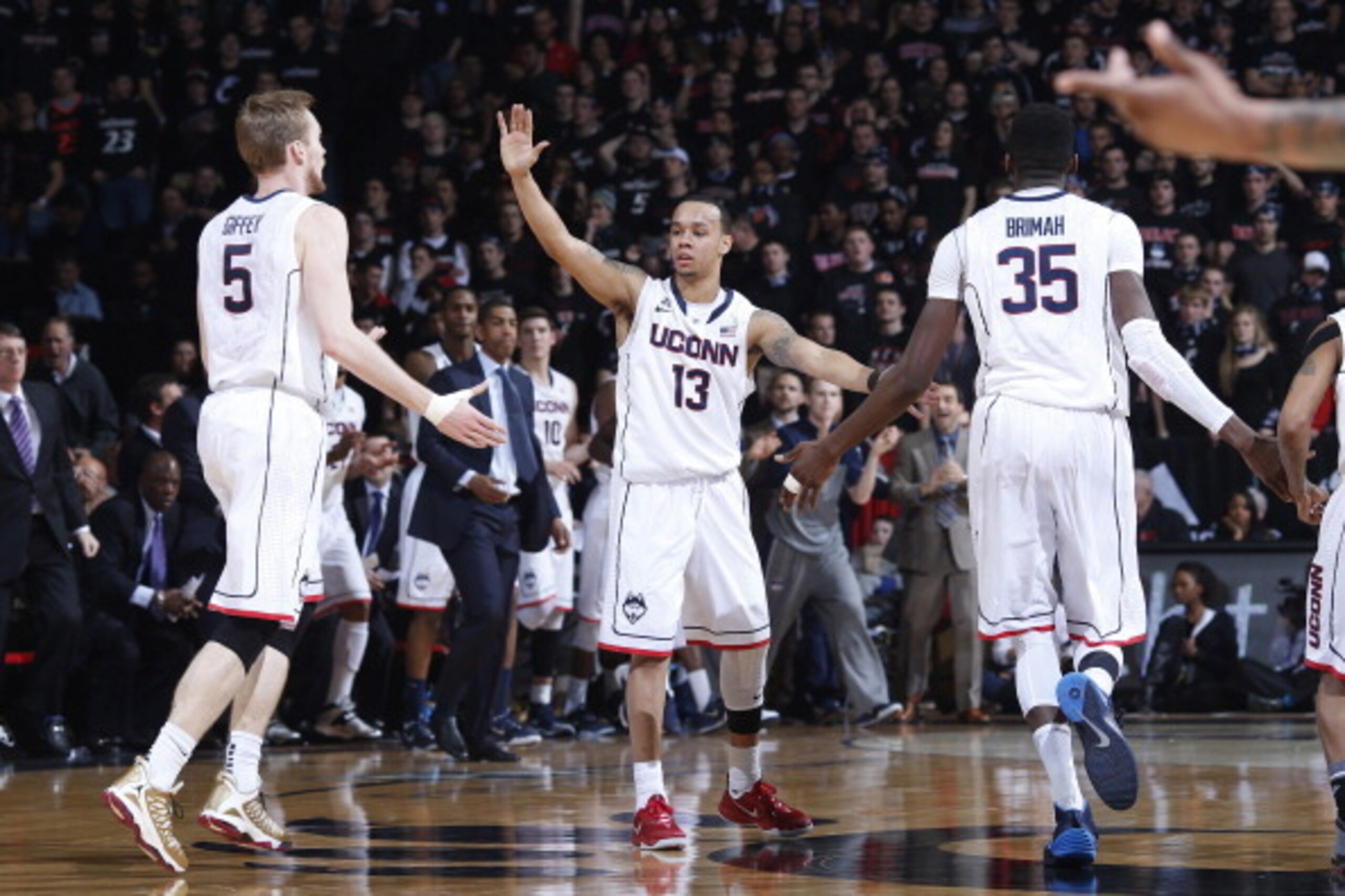 CINCINNATI, OH - FEBRUARY 6:  Shabazz Napier #13, Niels Giffey #5 and Amida Brimah #35 of the Connecticut Huskies celebrate against the Cincinnati Bearcats during the first half of the game against at Fifth Third Arena on February 6, 2014 in Cincinnati, O