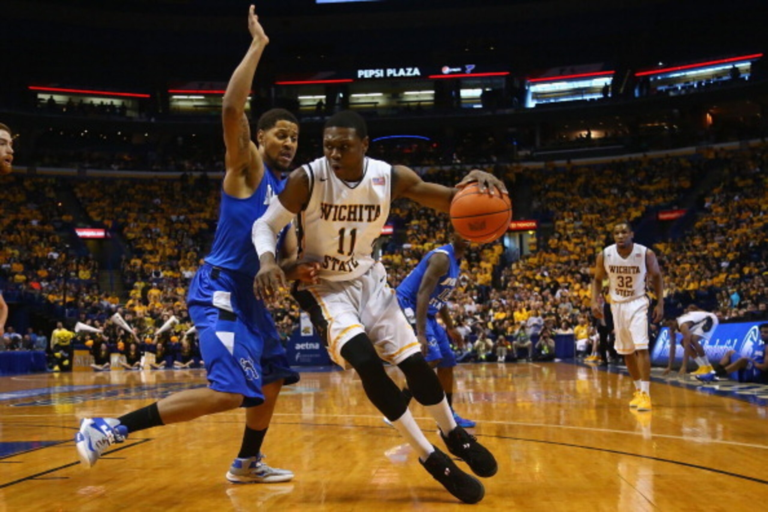 ST. LOUIS, MO - MARCH 9: Cleanthony Early #11 of the Wichita State Shockers looks to get past Khristian Smith #32 of the Indiana State Sycamores during the MVC Basketball Tournament Championship game at the Scottrade Center on March 9, 2014 in St. Louis, 