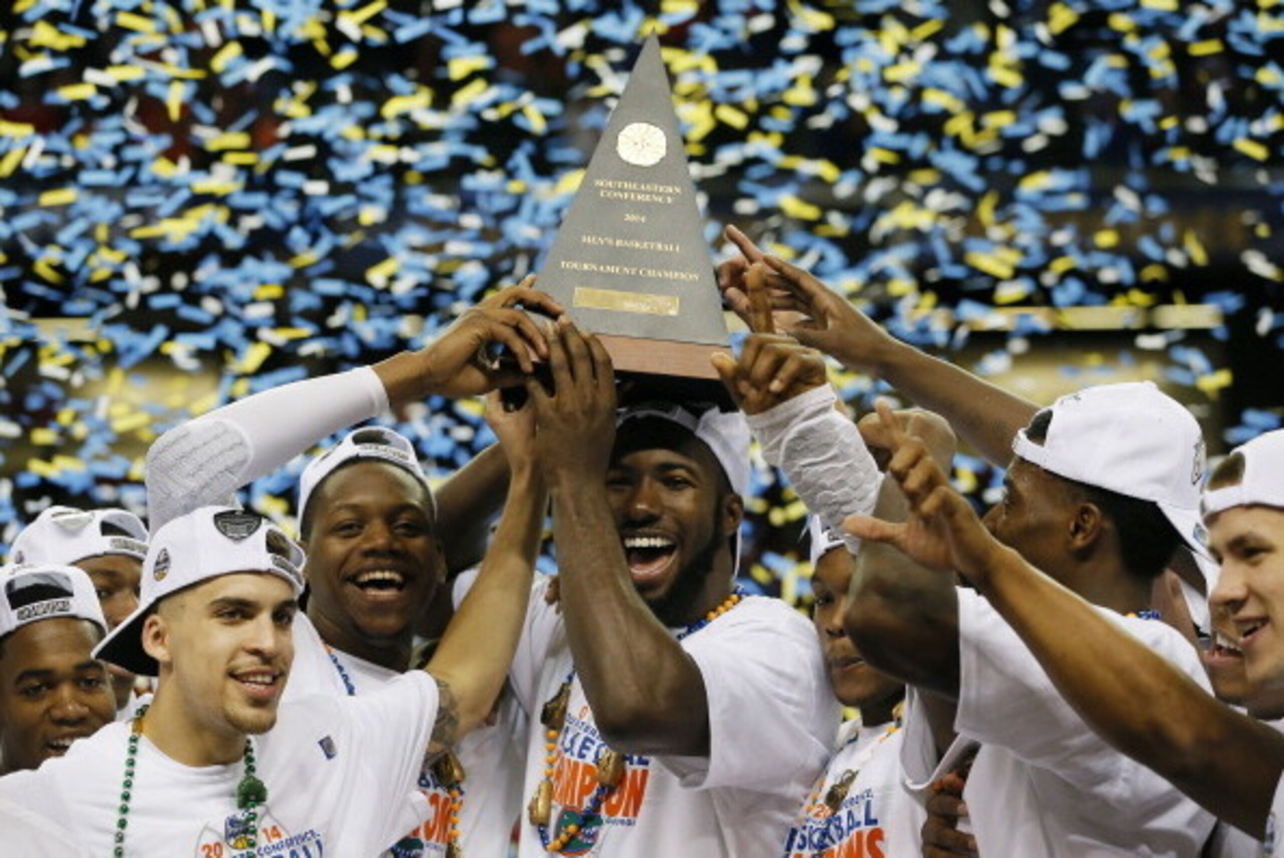 ATLANTA, GA - MARCH 16:  The Florida Gators celebrate with the trophy after their 61 to 60 win over the Kentucky Wildcats in the Championship game of the 2014 Men's SEC Basketball Tournament at Georgia Dome on March 16, 2014 in Atlanta, Georgia.  (Photo b