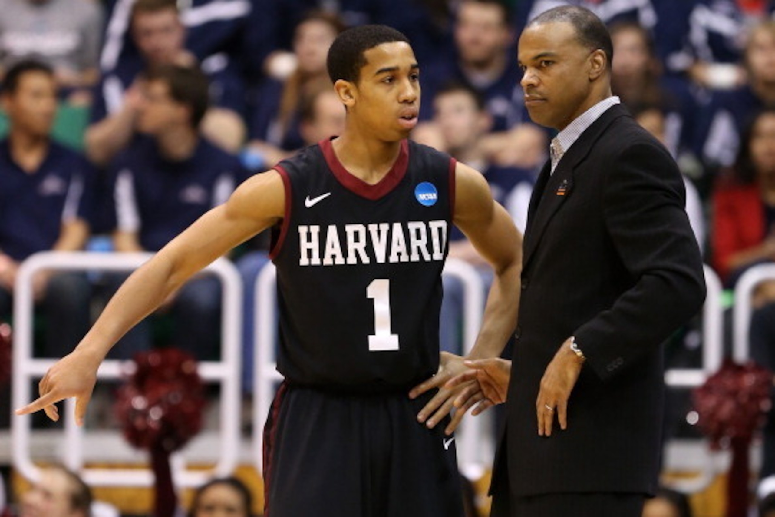 SALT LAKE CITY, UT - MARCH 23:  Siyani Chambers #1 talks with head coach Tommy Amaker of the Harvard Crimson in the first half while taking on the Arizona Wildcats during the third round of the 2013 NCAA Men's Basketball Tournament at EnergySolutions Aren