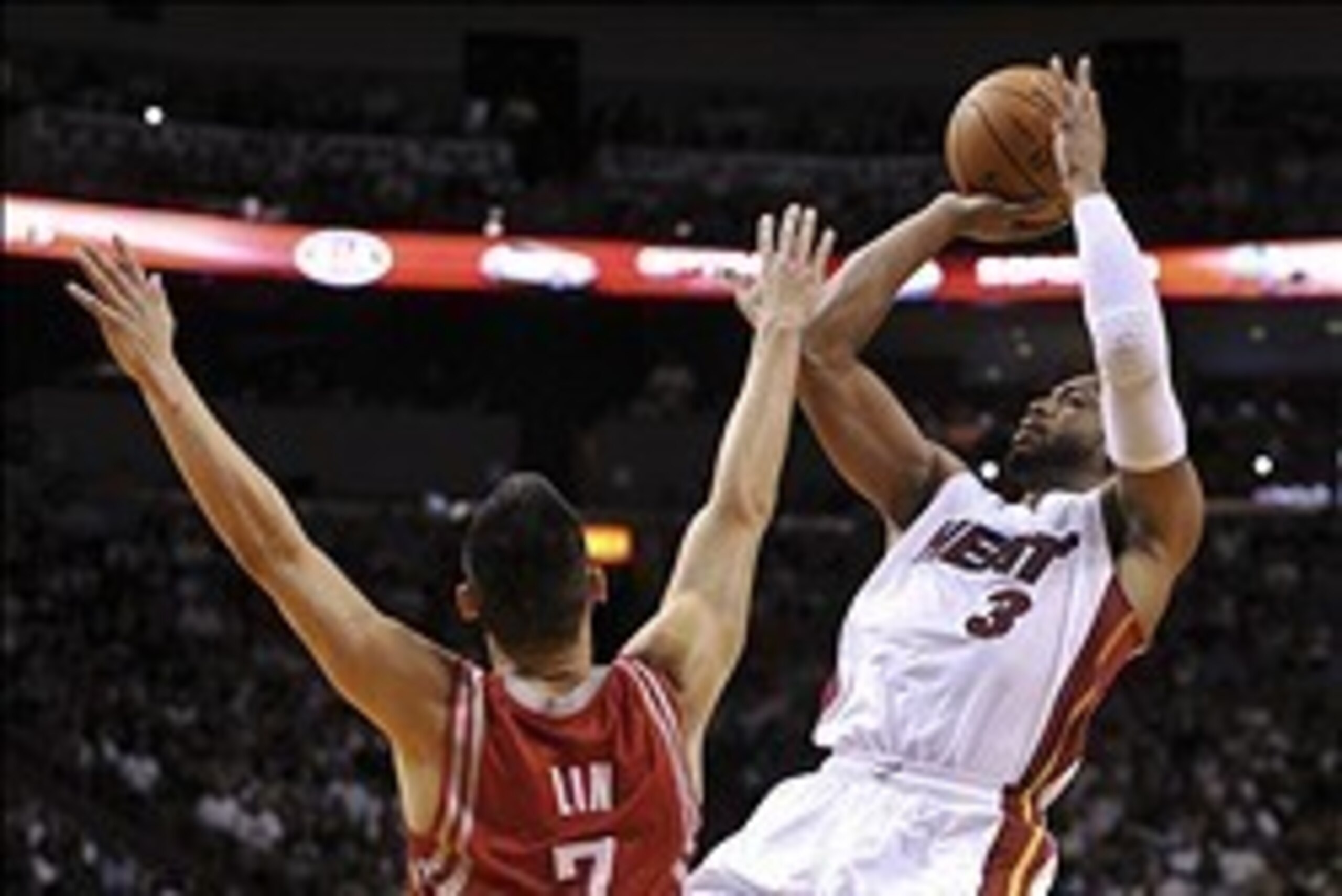 Mar 16, 2014; Miami, FL, USA; Miami Heat guard Dwyane Wade (3) shoots over Houston Rockets guard Jeremy Lin (7) during the second half at American Airlines Arena. Mandatory Credit: Steve Mitchell-USA TODAY Sports