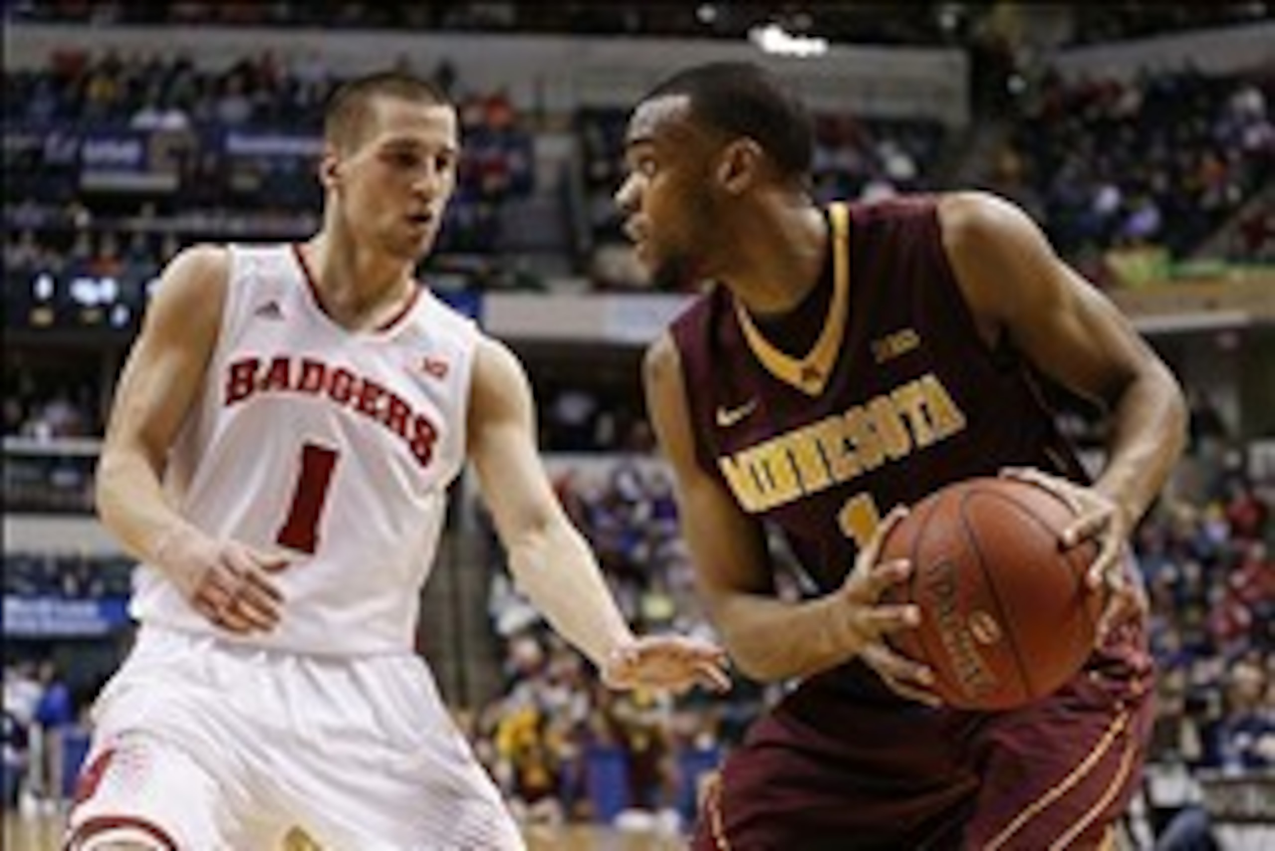 Mar 14, 2014; Indianapolis, IN, USA; Minnesota Golden Gophers guard Andre Hollins (1) is guarded by Wisconsin Badgers guard Ben Brust (1) in the quarterfinals of the Big Ten college basketball tournament at Bankers Life Fieldhouse. Mandatory Credit: Brian