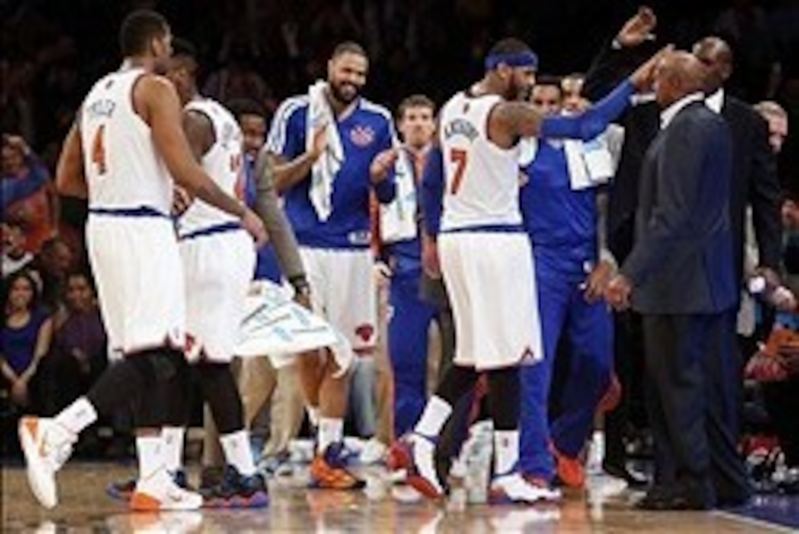 Jan 24, 2014; New York, NY, USA; New York Knicks small forward Carmelo Anthony (7) gives coach Mike Woodson a high five after scoring 62 total points during the game against the Charlotte Bobcats at Madison Square Garden. Mandatory Credit: Noah K. Murray-