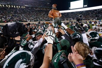 EAST LANSING, MI - NOVEMBER 02: The Michigan State Spartans carry off the Paul Bunyan Trophy as they celebrate their 29-6 win over the Michigan Wolverines at Spartan Stadium on November 2, 2013 in East Lansing, Michigan. (Photo by Gregory Shamus/Getty Ima