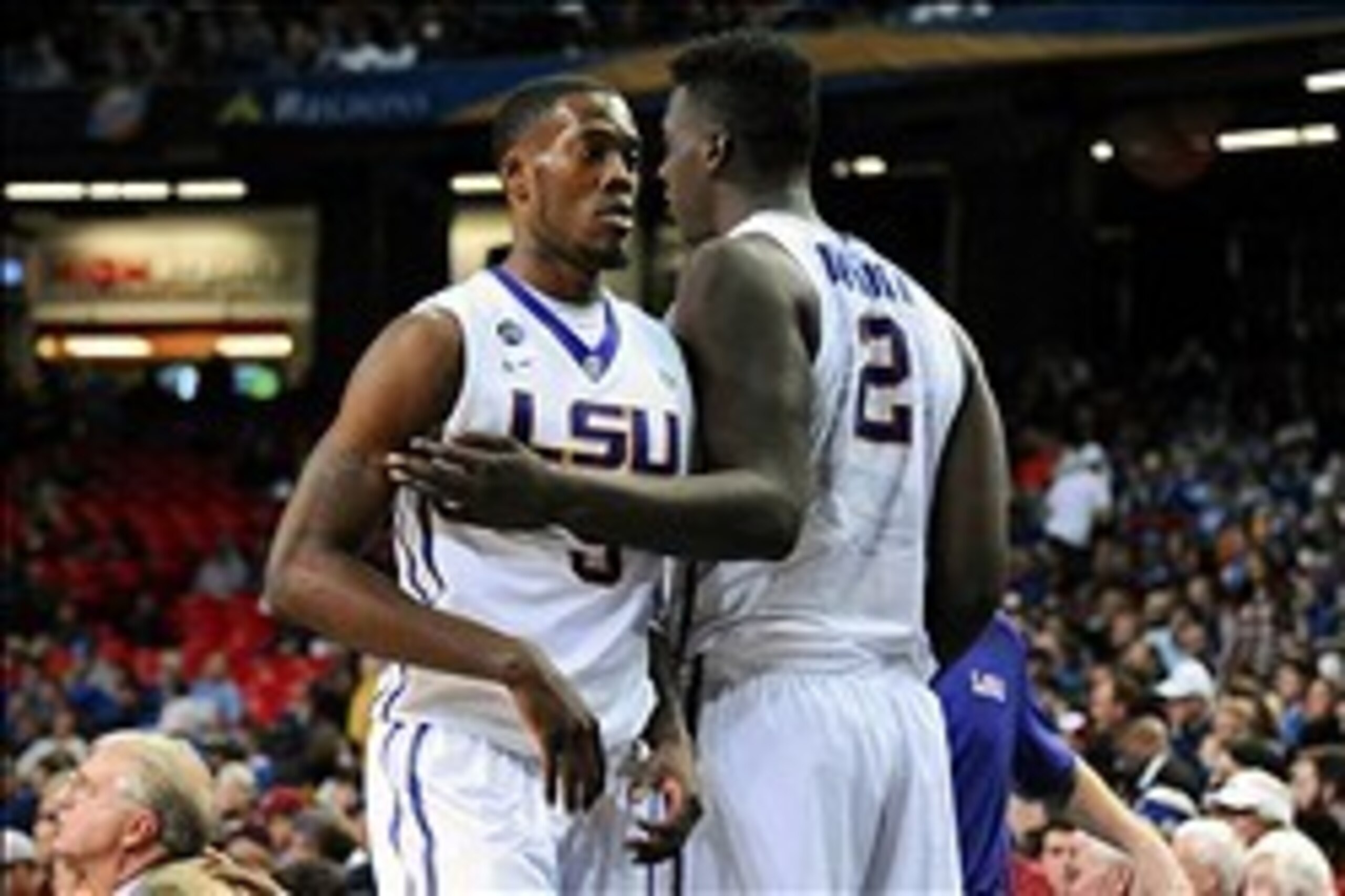 Mar 13, 2014; Atlanta, GA, USA; LSU Tigers forward Shavon Coleman (5) and forward Johnny O'Bryant III (2) react after defeating the Alabama Crimson Tide in the second round of the SEC college basketball tournament at Georgia Dome. LSU defeated Alabama 68-