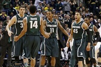 Mar 16, 2014; Indianapolis, IN, USA; Michigan State Spartans guard Gary Harris (14) is congratulated by guards Keith Appling (11) and Denzel Valentine (45) after dunking against the Michigan Wolverines in the championship game for the Big Ten college bask