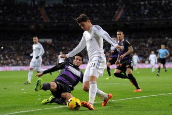 MADRID, SPAIN - NOVEMBER 30:  Alvaro Morata (R) of Real Madrid CF is tackled by Marc Valiente of Real Valladolid CF during the La Liga match between Real Madrid CF and Real Valladolid CF at Santiago Bernabeu stadium on November 30, 2013 in Madrid, Spain. 