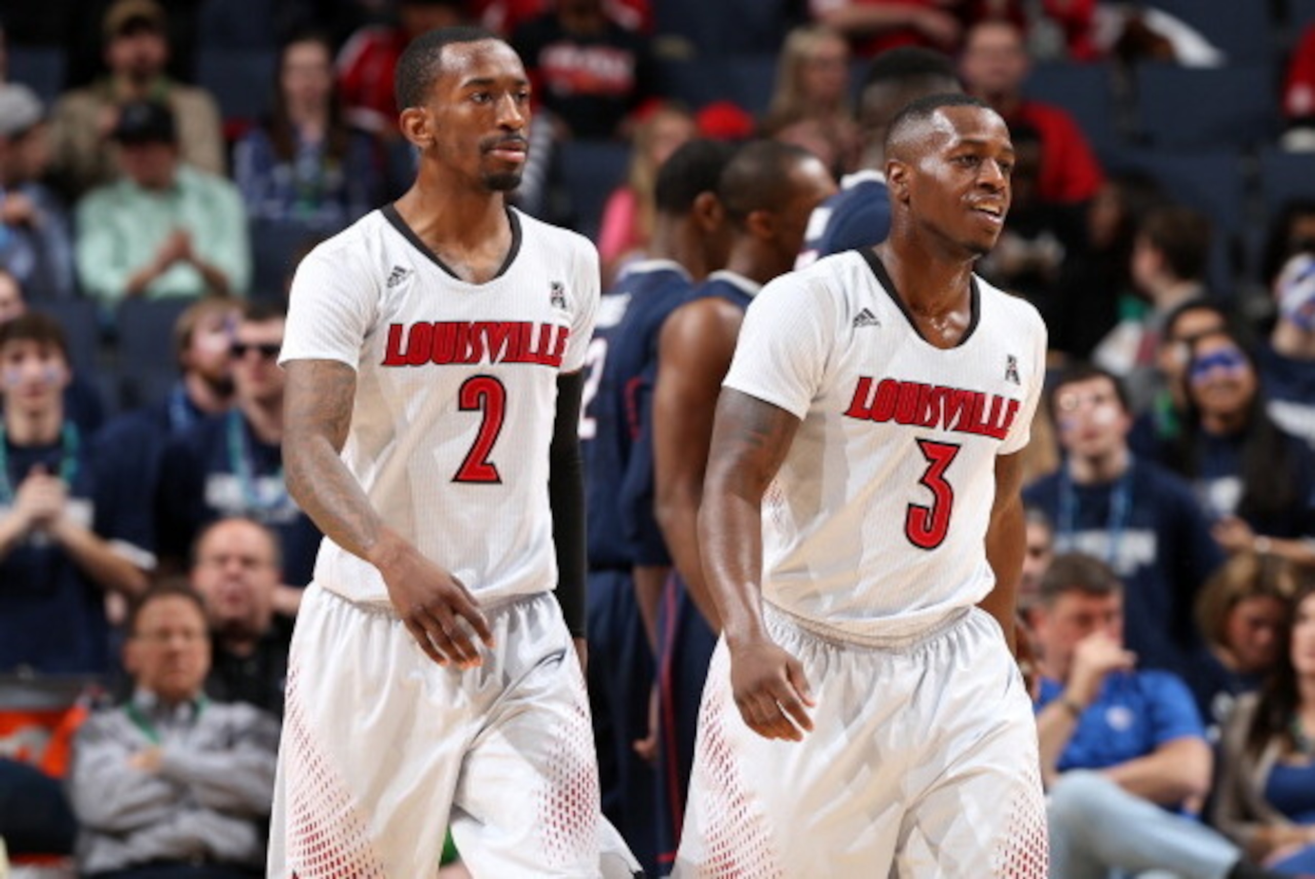 MEMPHIS, TN - MARCH 15: Russ Smith #2 and Chris Jones #3 of the Louisville Cardinals walk towards the bench against the Connecticut Huskies during the Championship of the American Athletic Conference Tournament at FedExForum on March 15, 2014 in Memphis, 
