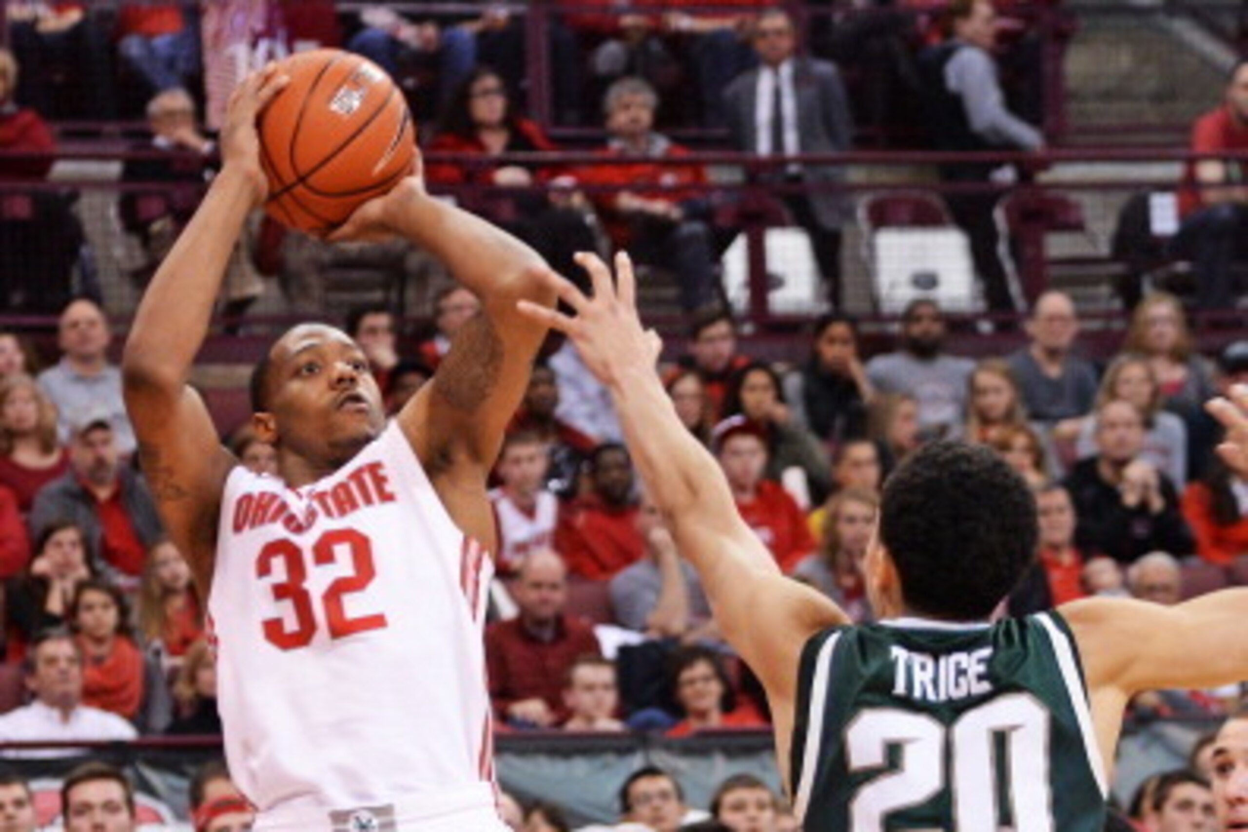 COLUMBUS, OH - MARCH 9:  Lenzelle Smith, Jr. #32 of the Ohio State Buckeyes shoots over the defense of Travis Trice #20 of the Michigan State Spartans in the second half on March 9, 2014 at Value City Arena in Columbus, Ohio.  Ohio State defeated Michigan