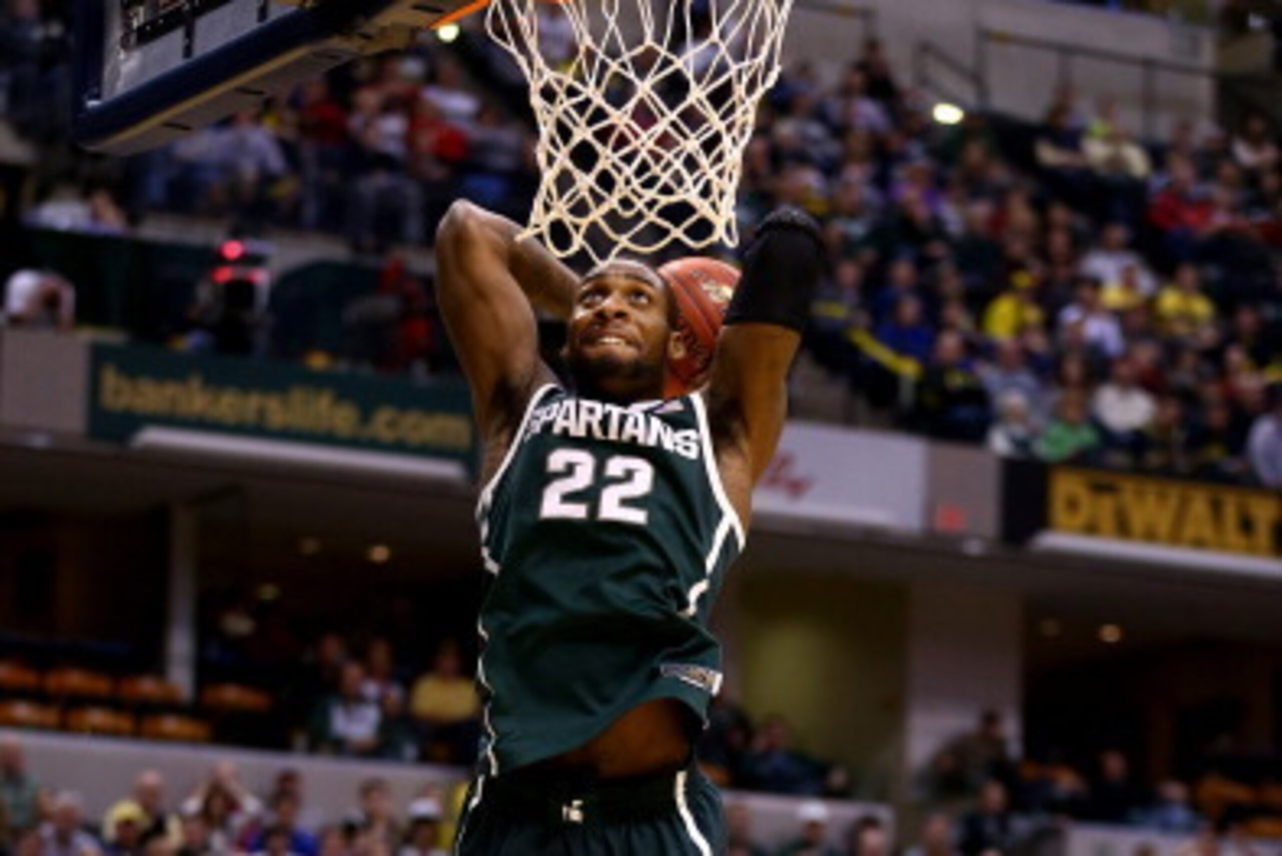 INDIANAPOLIS, IN - MARCH 16:  Branden Dawson #22 of the Michigan State Spartans dunks against the Michigan Wolverines during the 2014 Big Ten Men's Championship at Bankers Life Fieldhouse on March 16, 2014 in Indianapolis, Indiana.  (Photo by Andy Lyons/G