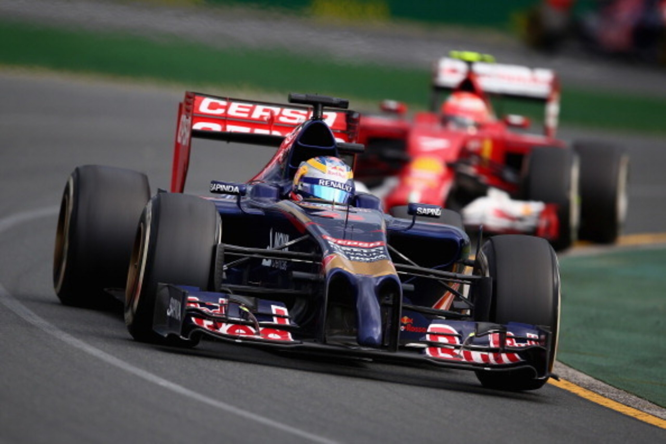 MELBOURNE, AUSTRALIA - MARCH 16:  Jean-Eric Vergne of France and Scuderia Toro Rosso leads from Kimi Raikkonen of Finland and Ferrari during the Australian Formula One Grand Prix at Albert Park on March 16, 2014 in Melbourne, Australia.  (Photo by Clive M