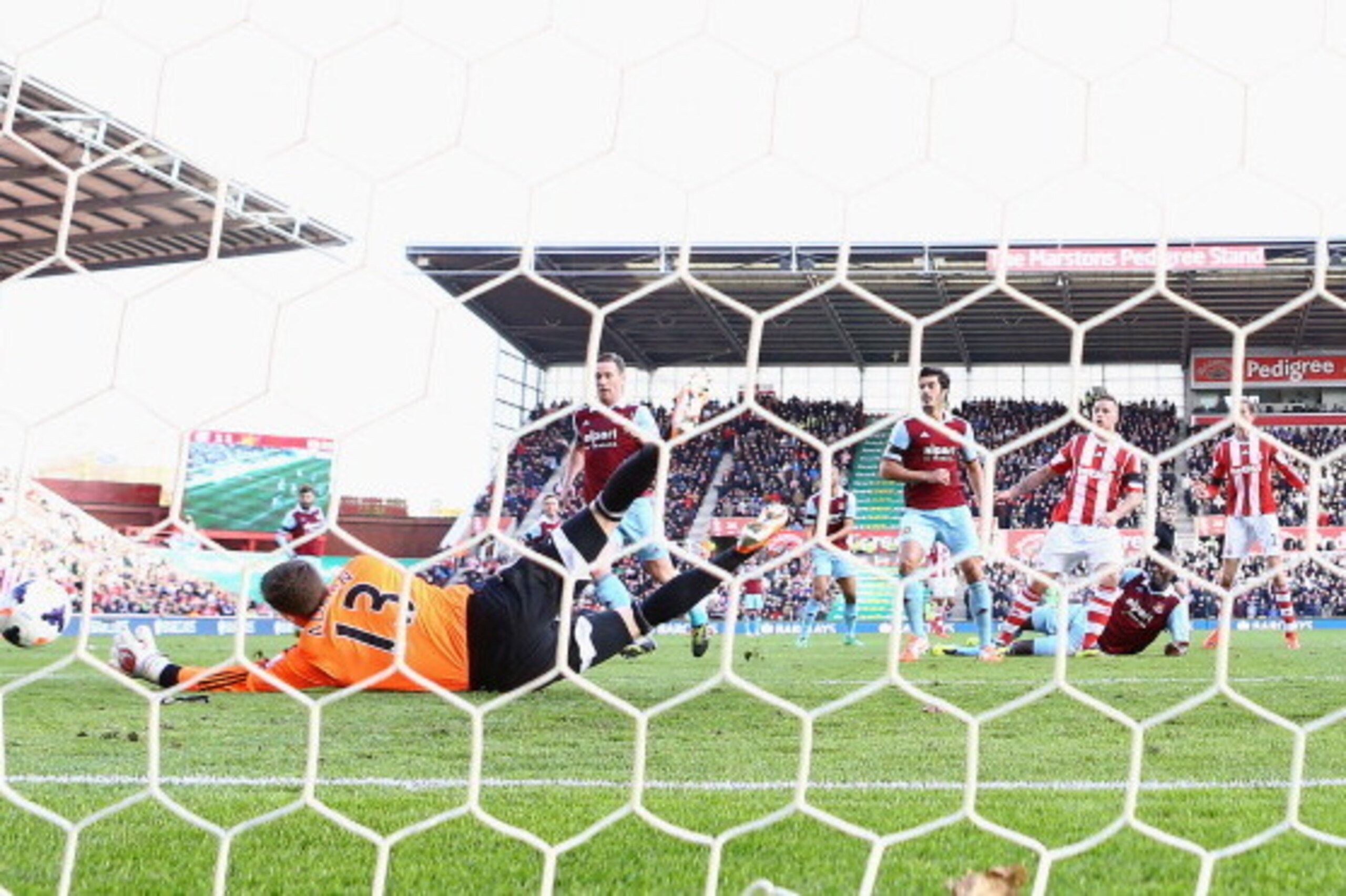 STOKE ON TRENT, ENGLAND - MARCH 15:  Marko Arnautovic of Stoke City shoots past Adrian of West Ham United to score their second goal during the Barclays Premier League match between Stoke City and West Ham United at Britannia Stadium on March 15, 2014 in 