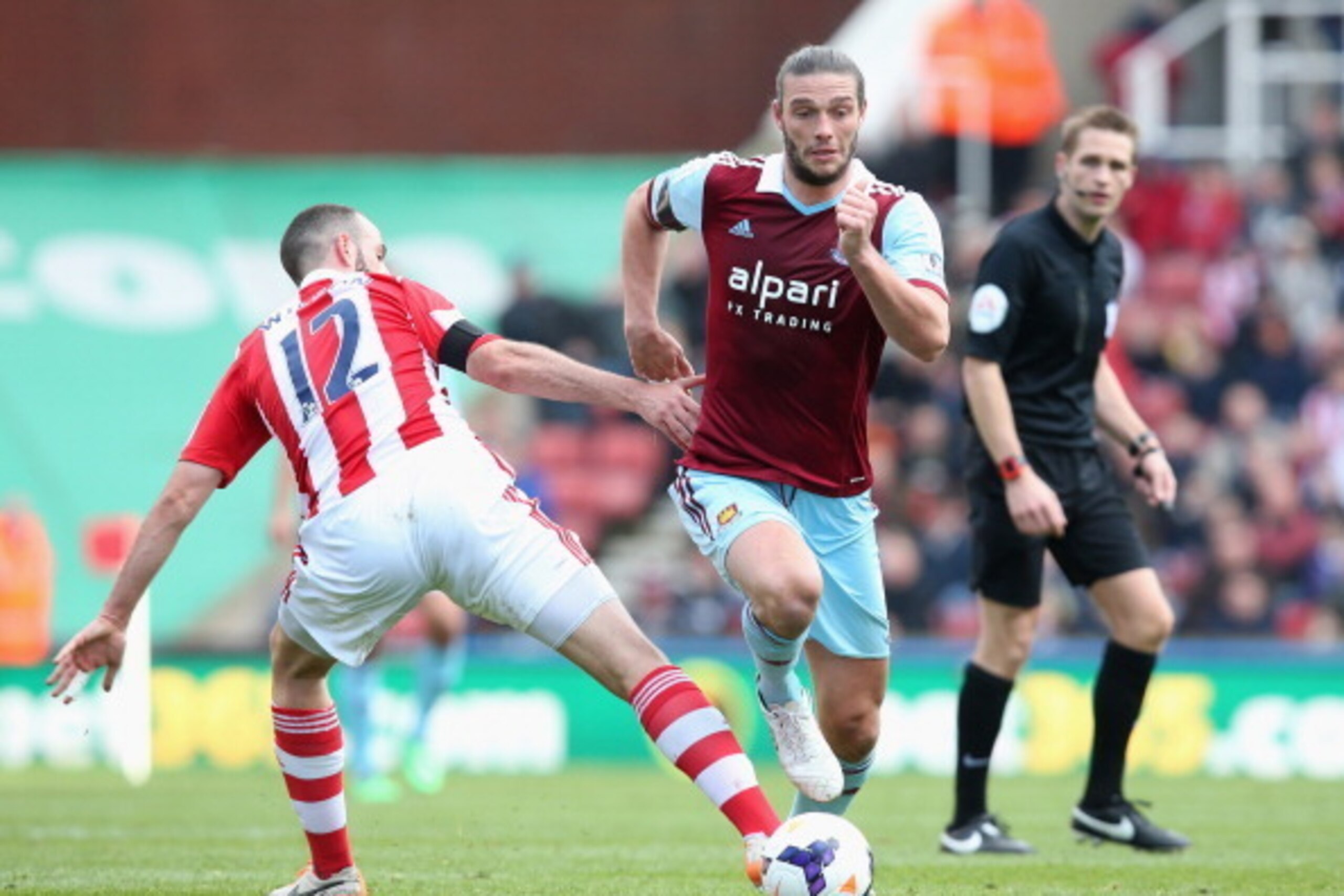 STOKE ON TRENT, ENGLAND - MARCH 15:  Andy Carroll of West Ham United evades Marc Wilson of Stoke City during the Barclays Premier League match between Stoke City and West Ham United at Britannia Stadium on March 15, 2014 in Stoke on Trent, England.  (Phot