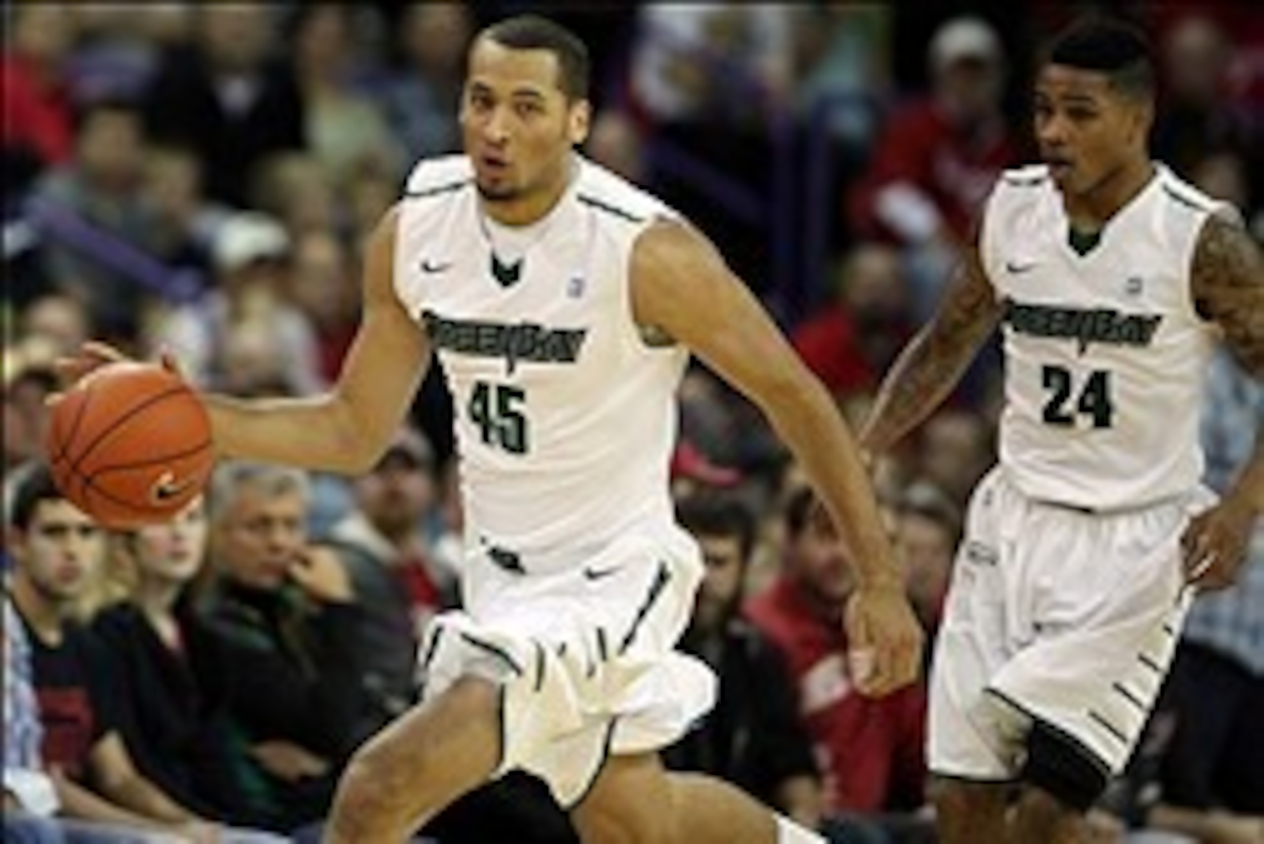 Nov 16, 2013; Green Bay, WI, USA; Wisconsin-Green Bay Phoenix forward Kenneth Lowe (45) dribbles the ball against the Wisconsin-Green Bay at the Resch Center. The Badgers won 69-66.  Mandatory Credit: Mary Langenfeld-USA TODAY Sports