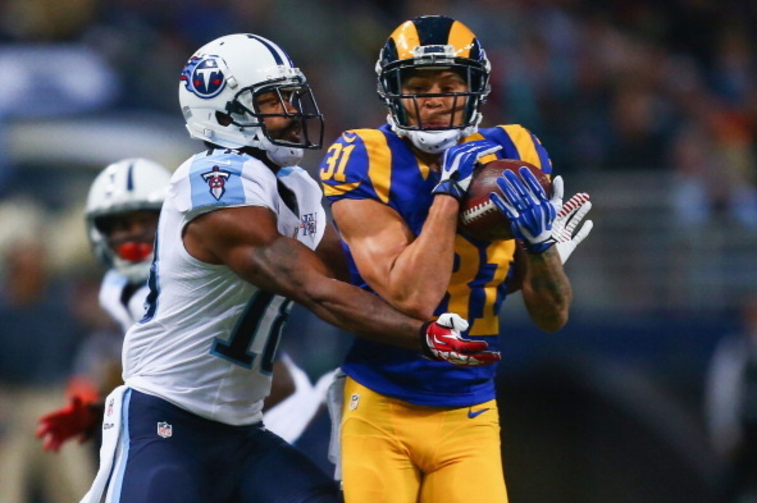ST. LOUIS, MO - NOVEMBER 3: Cortland Finnegan #31 of the St. Louis Rams intercepts a pass intended for Kenny Britt #18 of the Tennessee Titans at the Edward Jones Dome on November 3, 2013 in St. Louis, Missouri.  (Photo by Dilip Vishwanat/Getty Images)
