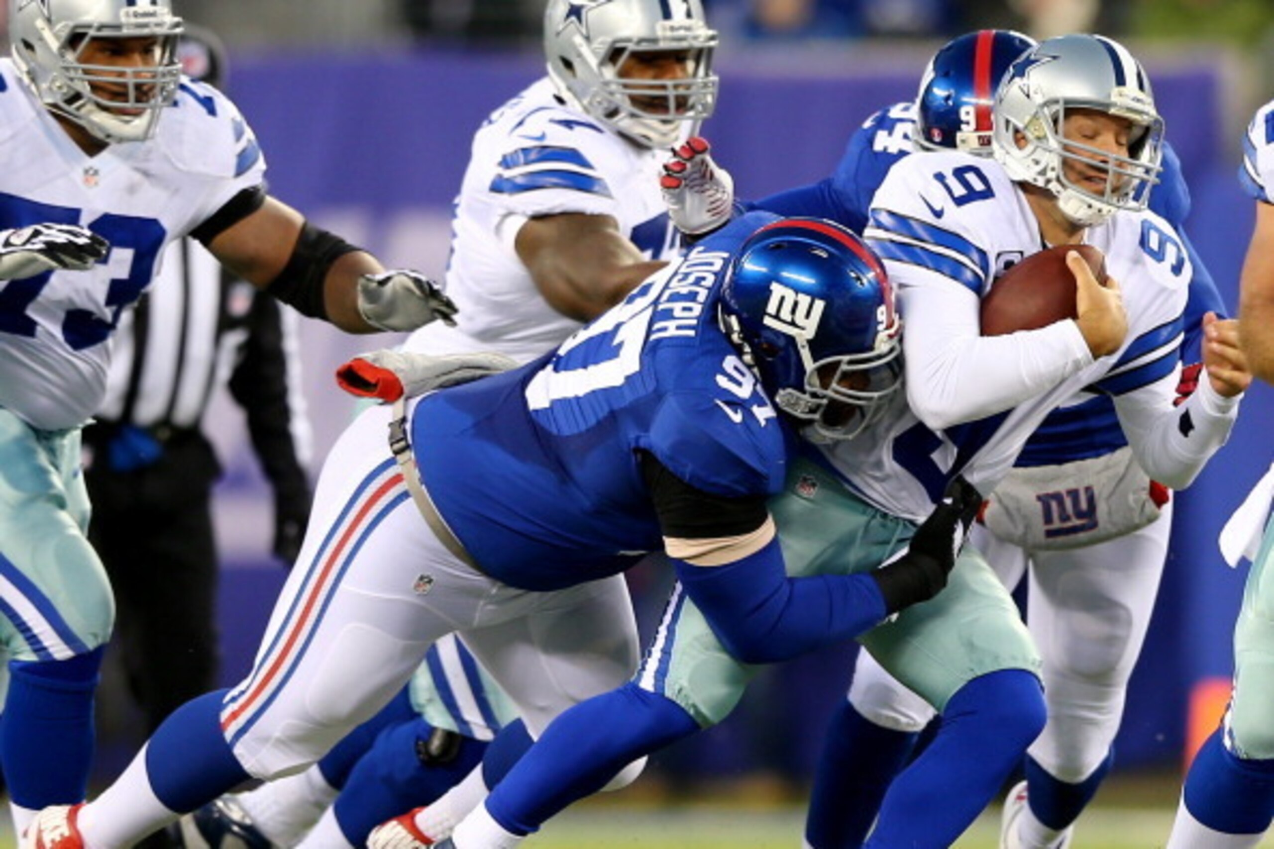 EAST RUTHERFORD, NJ - NOVEMBER 24:  Tony Romo #9 of the Dallas Cowboys is sacked by Linval Joseph #97 of the New York Giants at MetLife Stadium on November 24, 2013 in East Rutherford, New Jersey.  (Photo by Elsa/Getty Images)