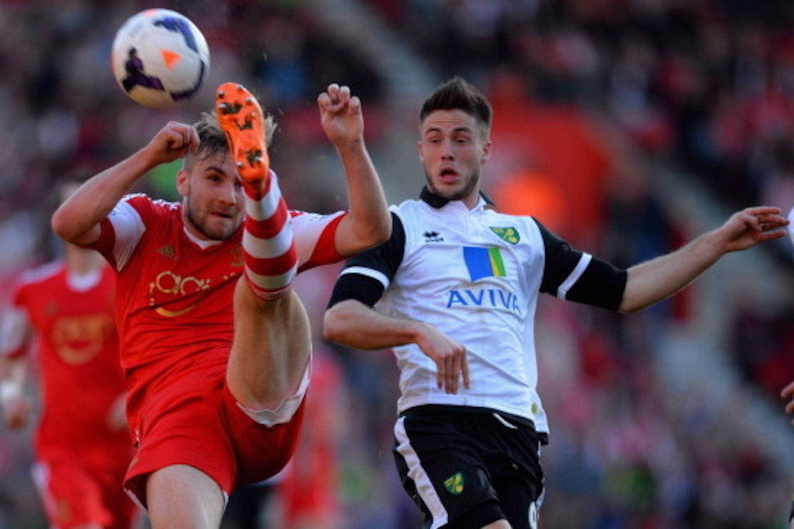 SOUTHAMPTON, ENGLAND - MARCH 15:  Luke Shaw of Southampton clears the ball from Ricky van Wolfswinkel of Norwich during the Barclays Premier League match between Southampton and Norwich City at St Mary's Stadium on March 15, 2014 in Southampton, England. 