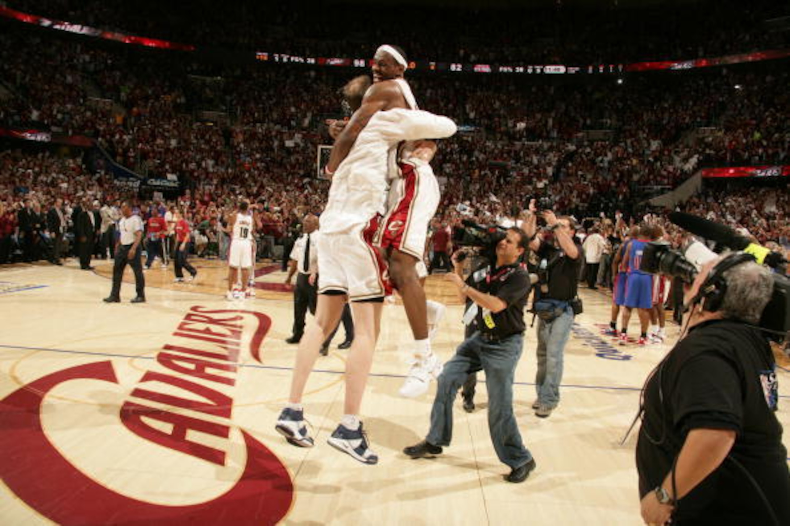 CLEVELAND - JUNE 02: Zydrunas Ilgauskas #11 and LeBron James #23 of the Cleveland Cavaliers celebrate after clinching the Eastern Conference Championship with a 98 to 82 victory over the Detroit Pistons in Game Six of the Eastern Conference Finals during 