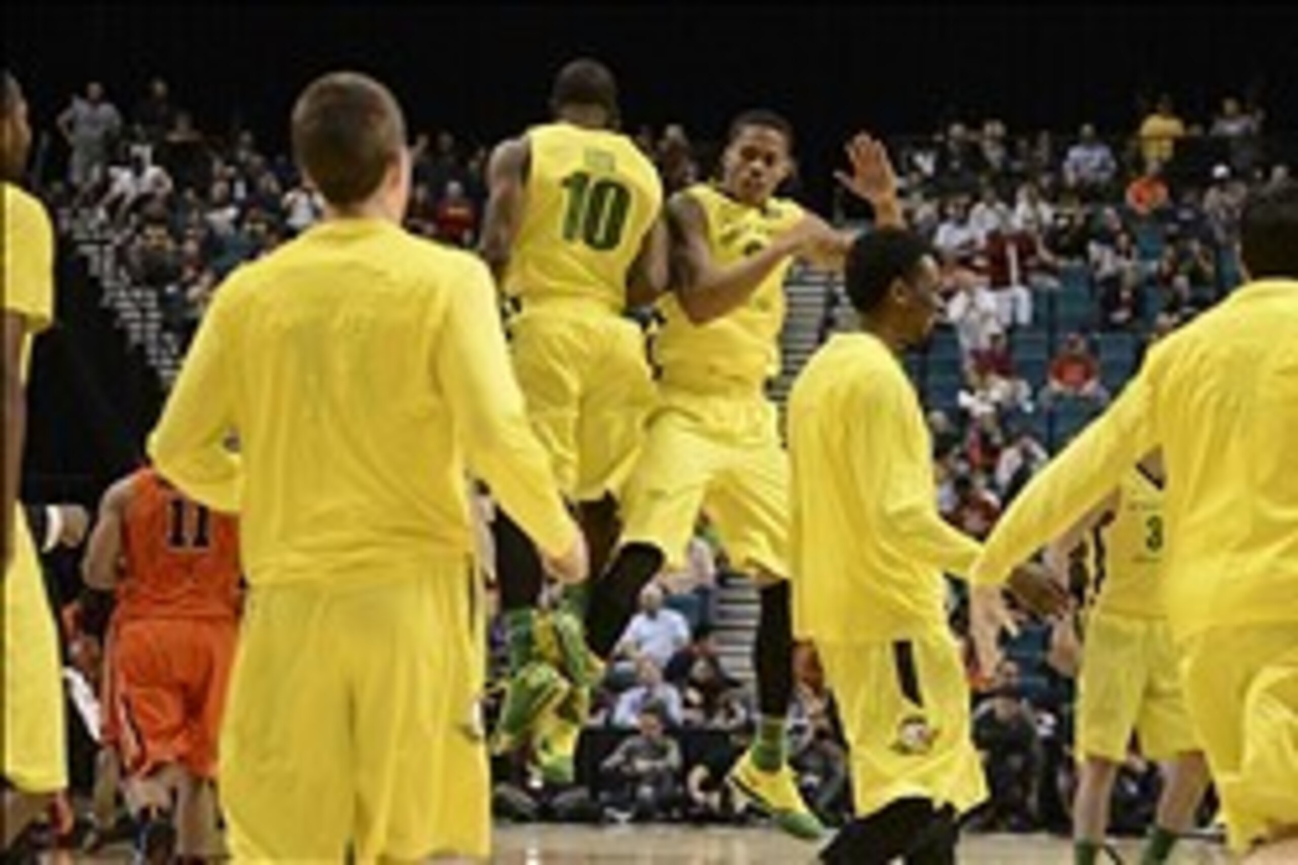 Mar 12, 2014; Las Vegas, NV, USA; Oregon Ducks guard Johnathan Loyd (10) and guard Joseph Young (3) celebrate against the Oregon State Beavers during the second half in the first round of the Pac-12 Conference Tournament at MGM Grand Garden Arena. The Duc