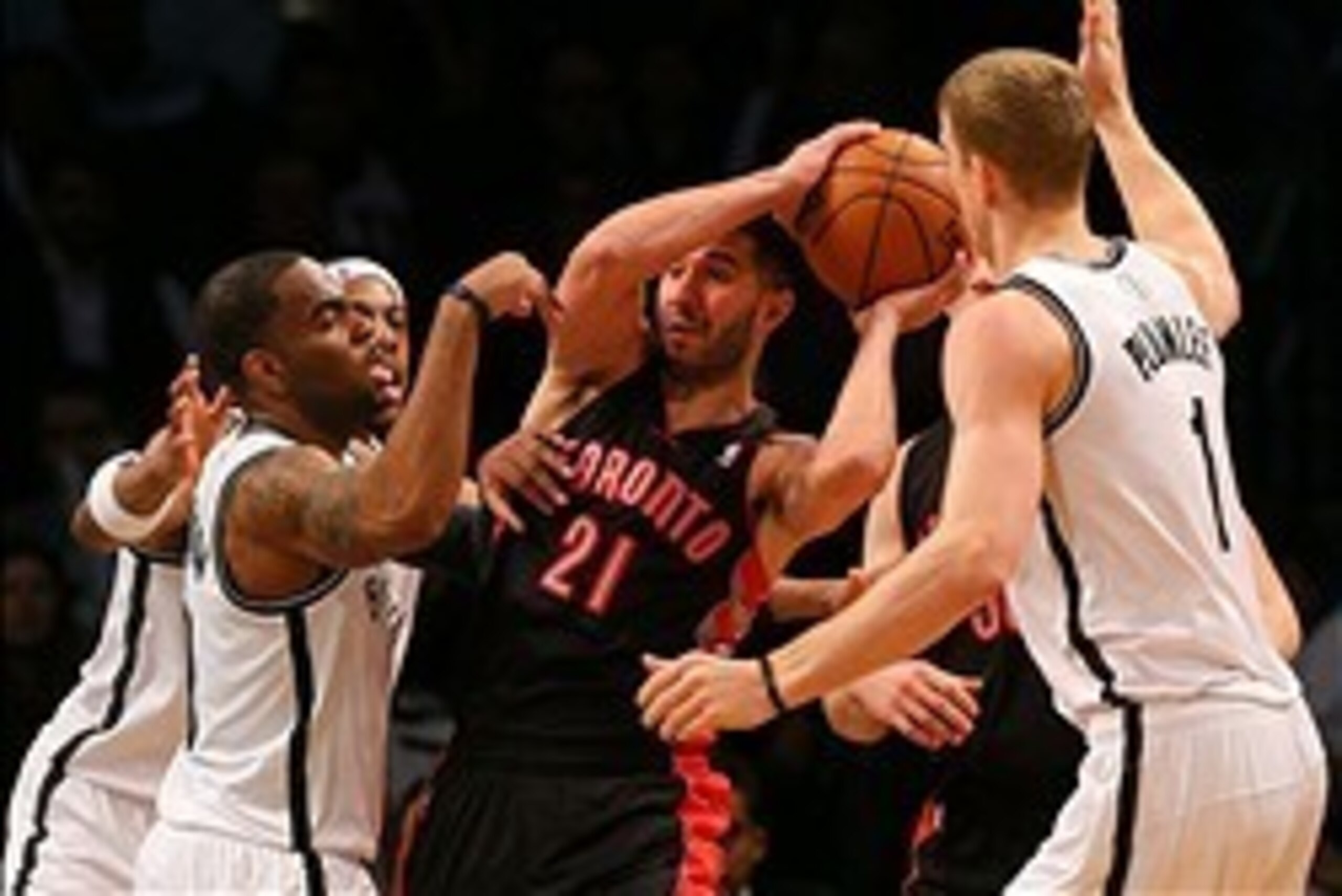 Mar 10, 2014; Brooklyn, NY, USA; Toronto Raptors point guard Greivis Vasquez (21) looks to pass defended by the Brooklyn Nets during the fourth quarter at the Barclays Center. The Brooklyn Nets defeated the Toronto Raptors 101-97. Mandatory Credit: Adam H
