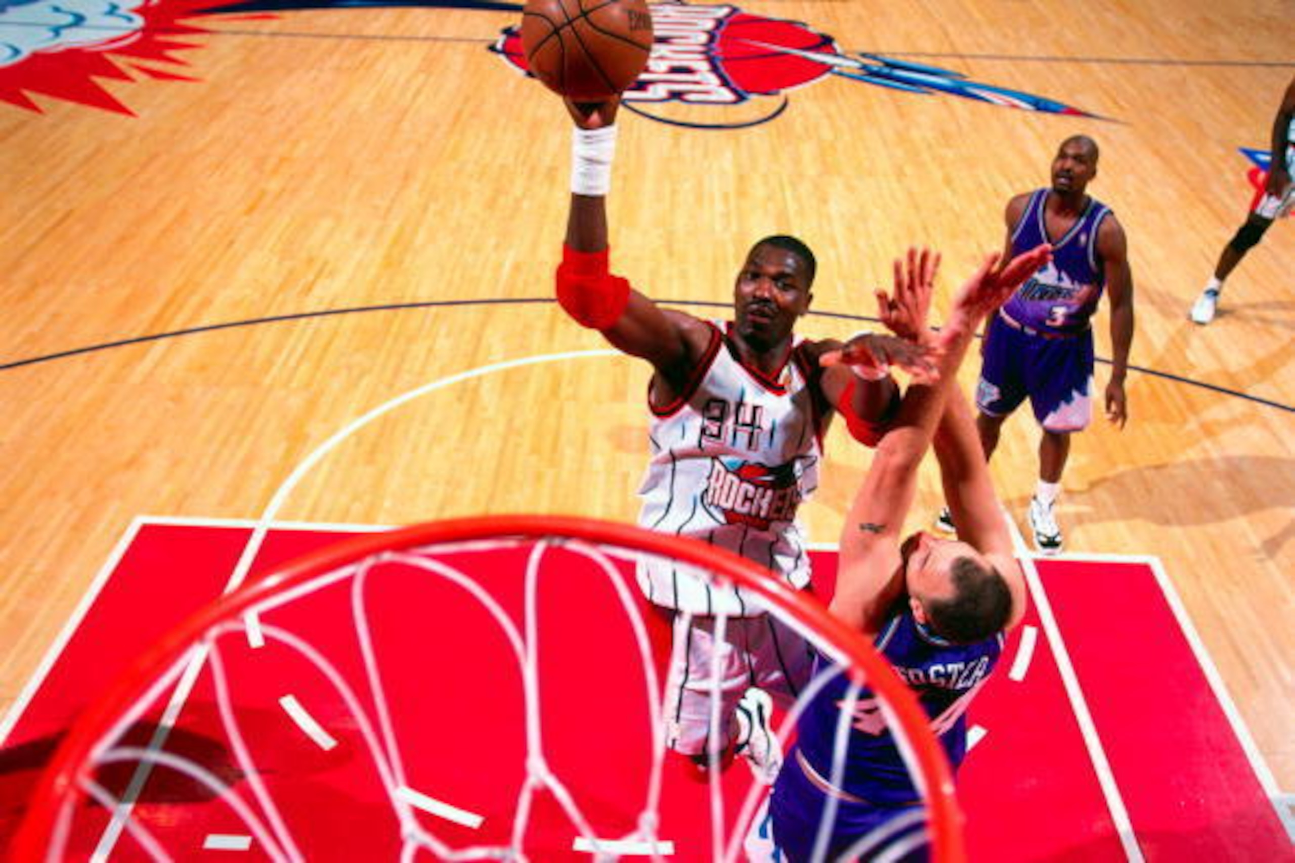 HOUSTON - MAY 25:  Hakeem Olajuwon #34 of the Houston Rockets shoots against Greg Foster #44 of the Utah Jazz in Game Four of the Western Conference Finals during the 1997 NBA Playoffs at the Compaq Center on May 25, 1997 in Houston, Texas. The Rockets wo
