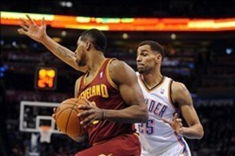 Feb 26, 2014; Oklahoma City, OK, USA; Cleveland Cavaliers power forward Tristan Thompson (13) handles the ball against Oklahoma City Thunder shooting guard Thabo Sefolosha (25) during the first quarter at Chesapeake Energy Arena. Mandatory Credit: Mark D.