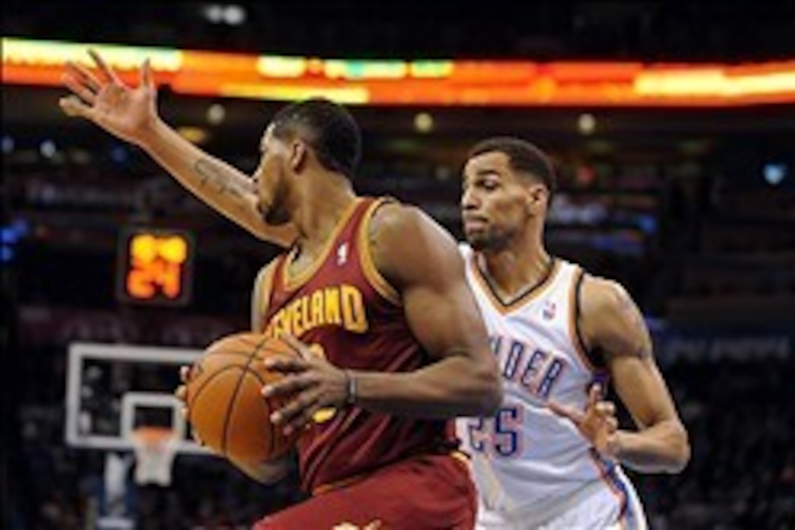 Feb 26, 2014; Oklahoma City, OK, USA; Cleveland Cavaliers power forward Tristan Thompson (13) handles the ball against Oklahoma City Thunder shooting guard Thabo Sefolosha (25) during the first quarter at Chesapeake Energy Arena. Mandatory Credit: Mark D.