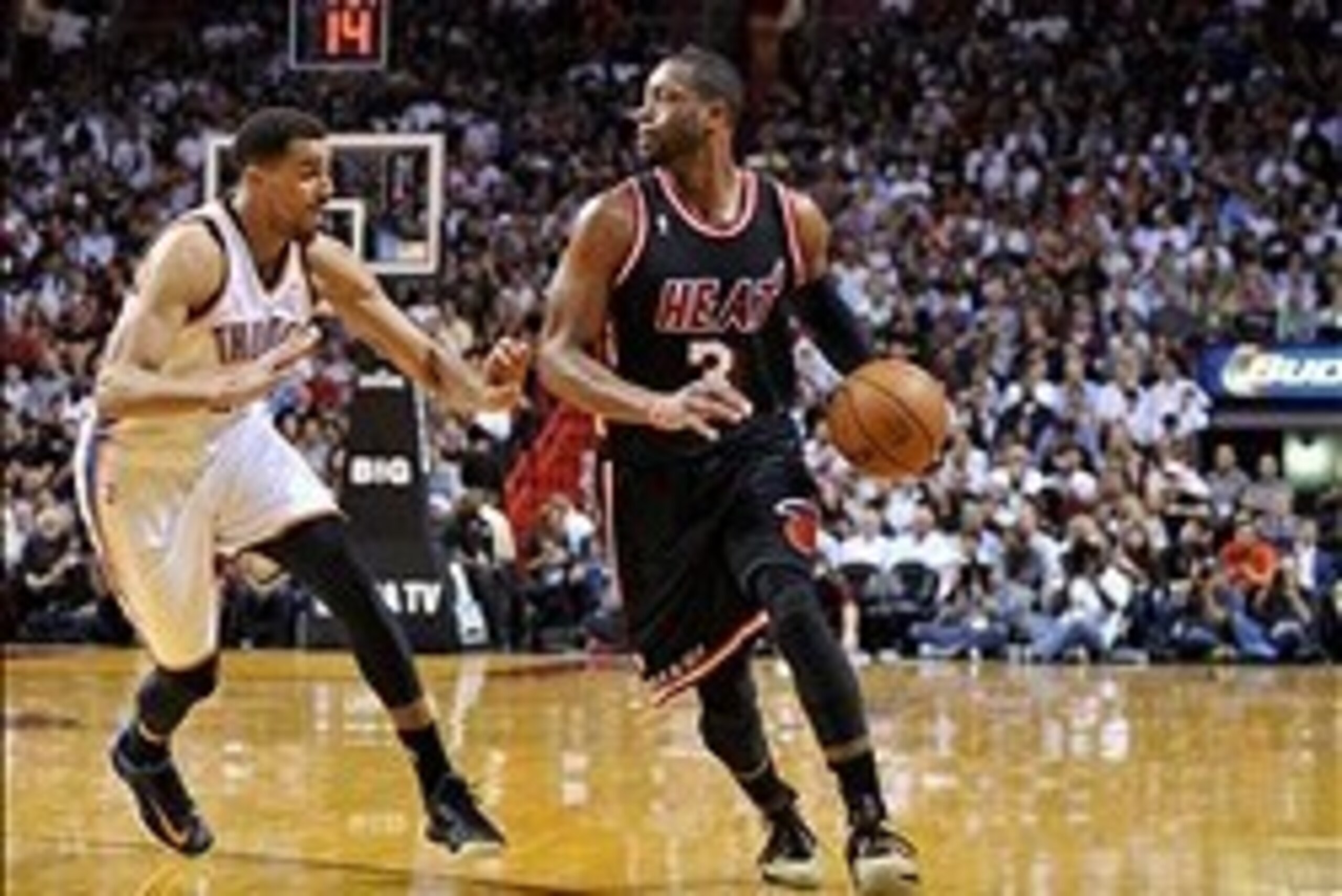 Jan 29, 2014; Miami, FL, USA; Oklahoma City Thunder shooting guard Thabo Sefolosha (25) applies pressure to Miami Heat shooting guard Dwyane Wade (3) during the second half at American Airlines Arena. Mandatory Credit: Steve Mitchell-USA TODAY Sports